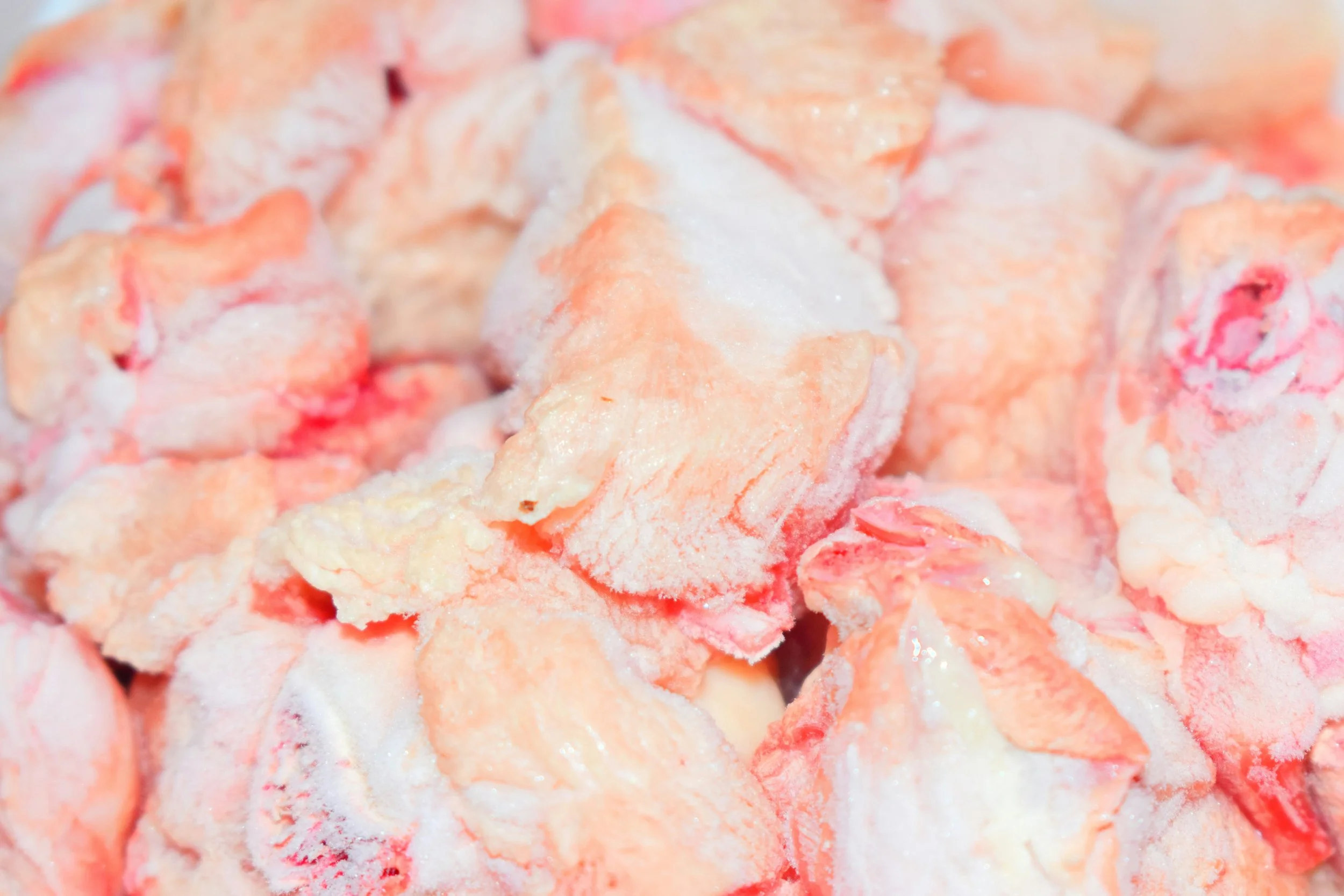 Close-up of frozen chunks of salmon with ice crystals.