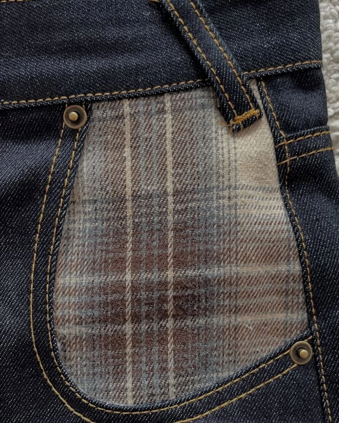 The rivets on jeans started as a practical solution rather than a design detail. In 1873, Levi Strauss and tailor Jacob Davis patented a method of reinforcing the points where work trousers were most likely to tear, particularly around the pockets an