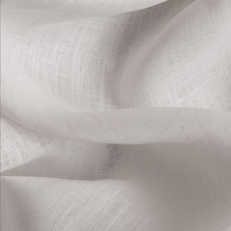 Close-up of white fabric with a soft, flowing texture.