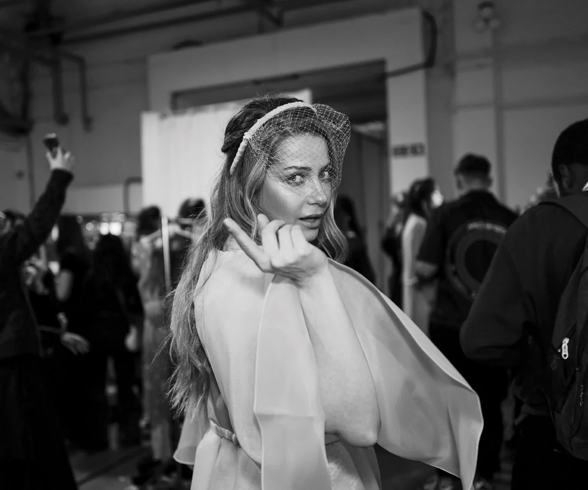 Behind-the-scenes runway fashion photography capturing backstage moments before the show begins