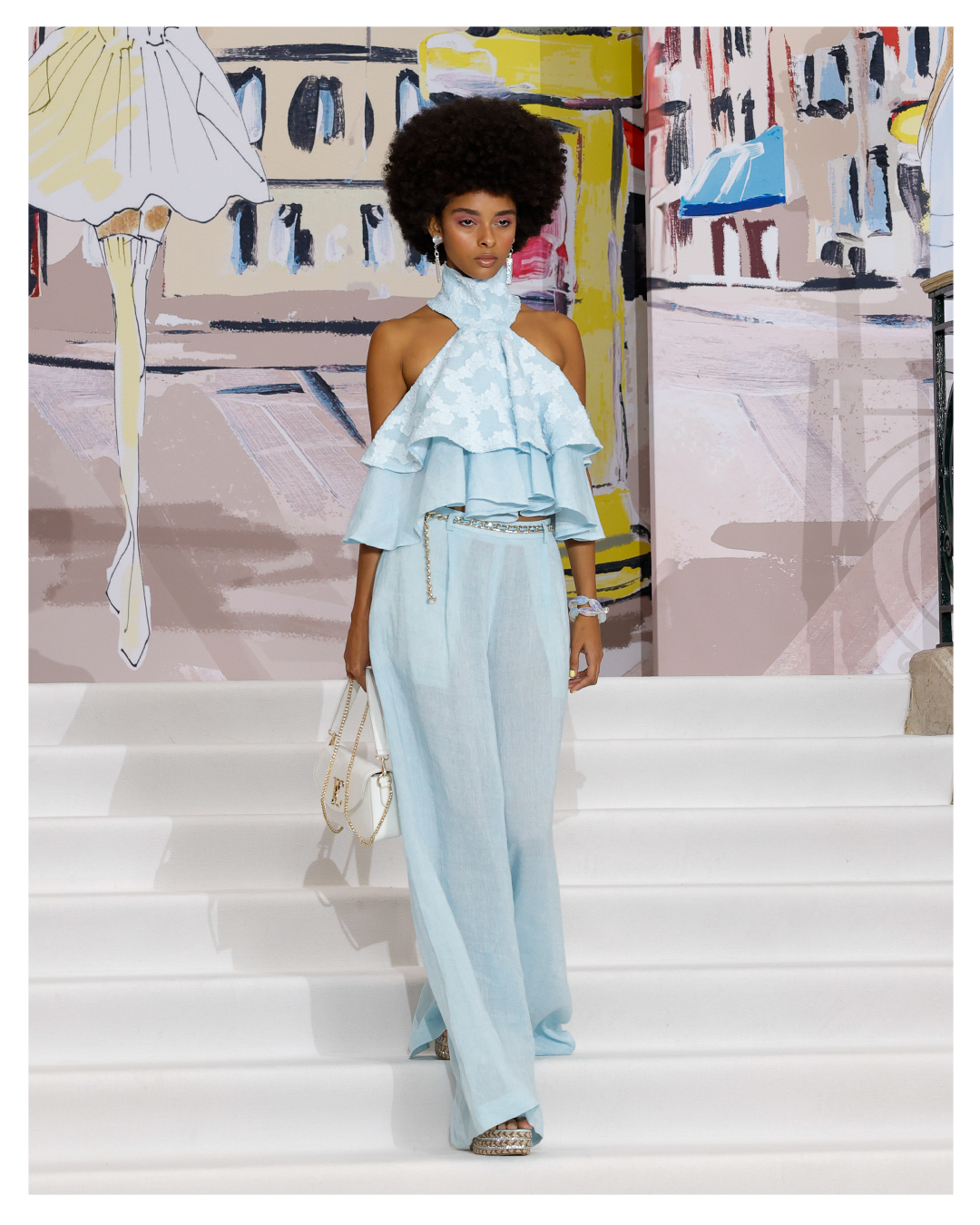 Runway fashion photography of a model walking during a live fashion show