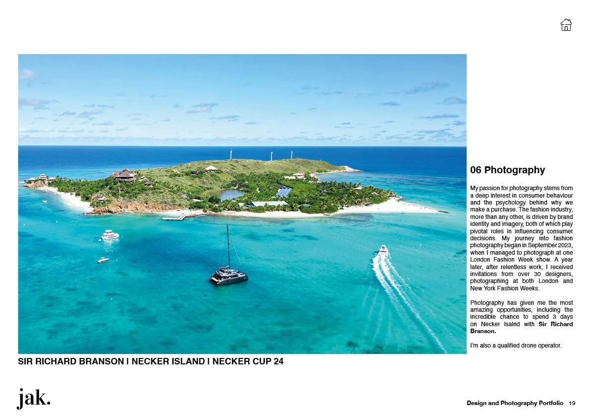 An aerial view of Necker Island with turquoise water, boats, and lush green land under a partly cloudy sky.