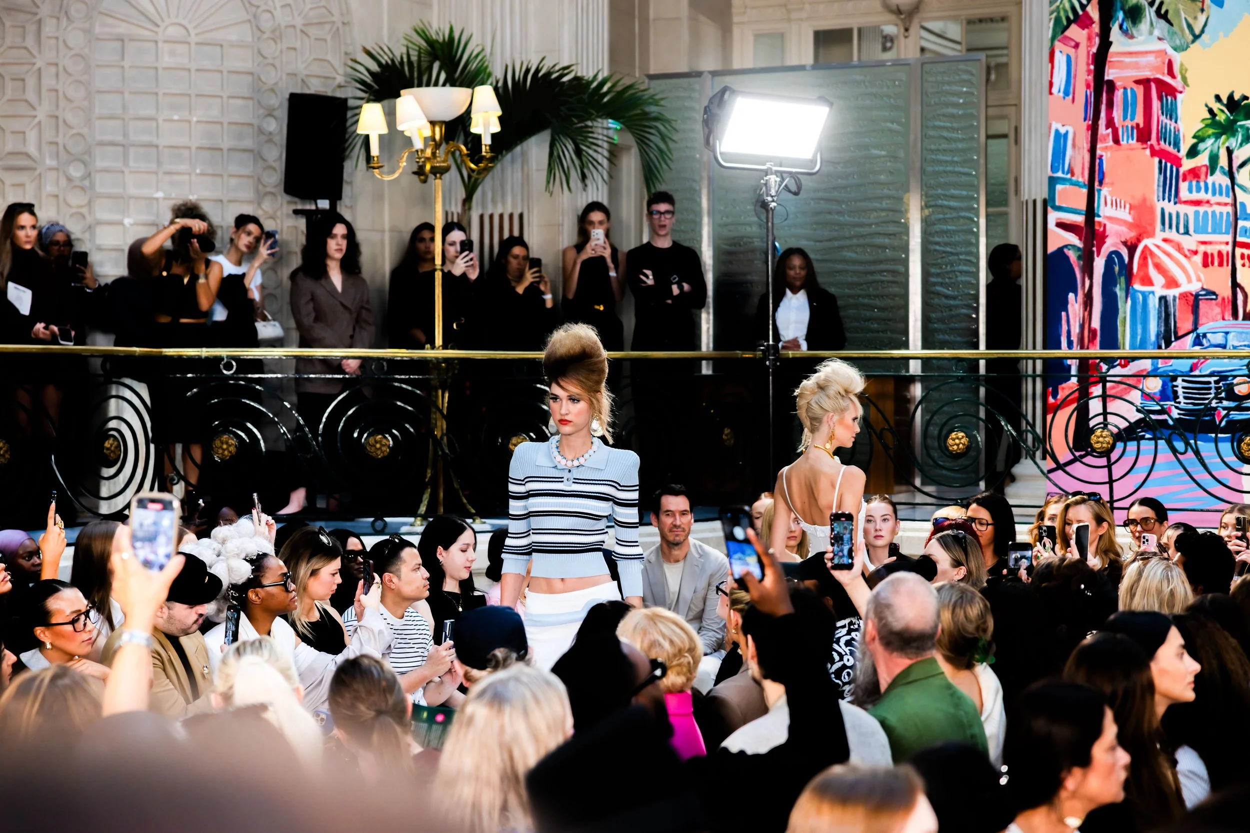 Fashion week catwalk photography showing a model presenting a runway look.