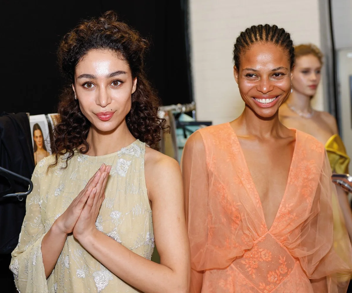 Editorial behind-the-scenes fashion photography capturing a candid live moment backstage