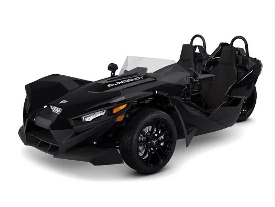 Black Polaris Slingshot three-wheeled vehicle with a low profile and open cockpit.