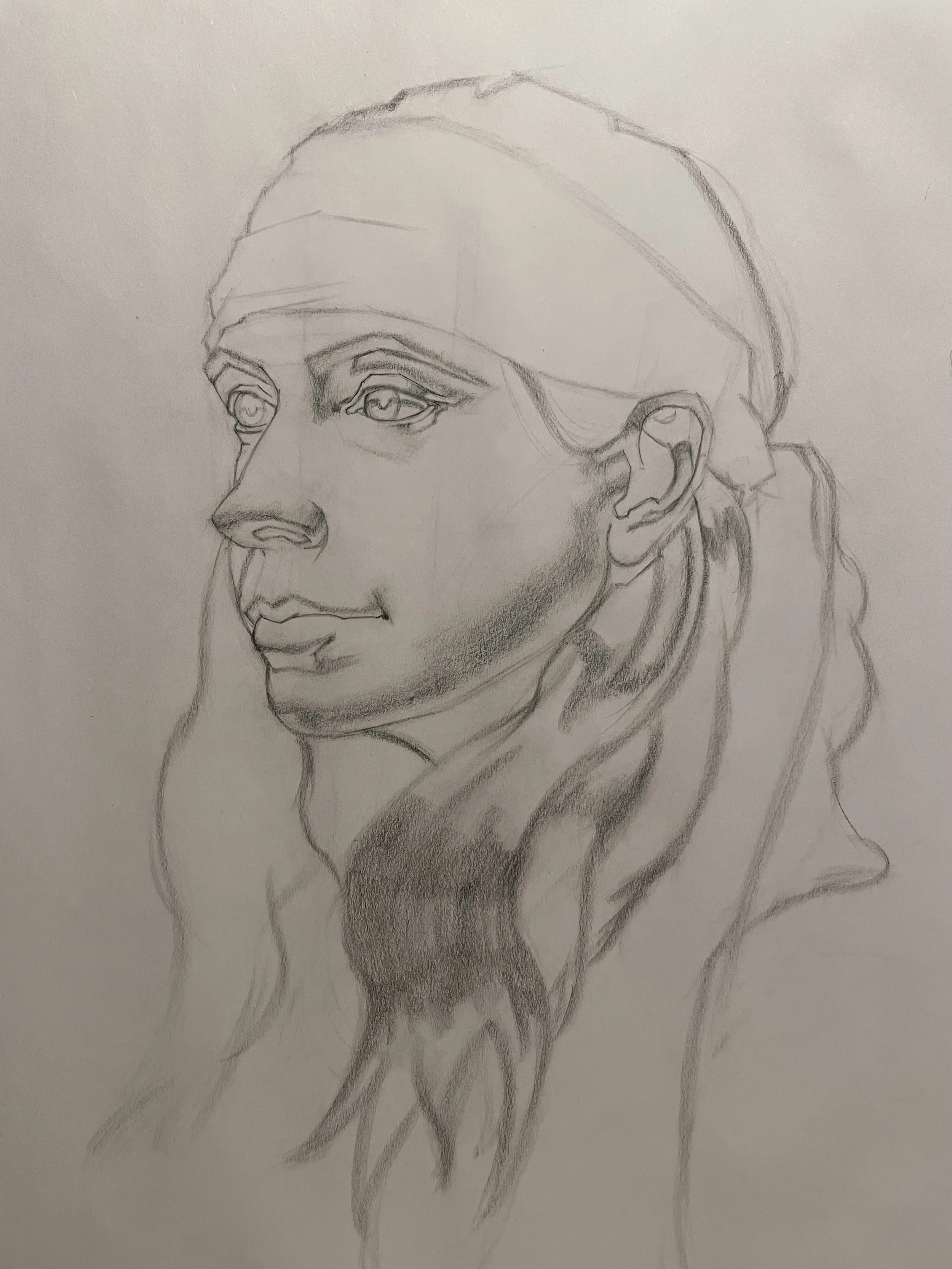 A pencil sketch of a woman with long hair, turned slightly to the left, wearing a headscarf, with detailed facial features and shaded areas for depth.
