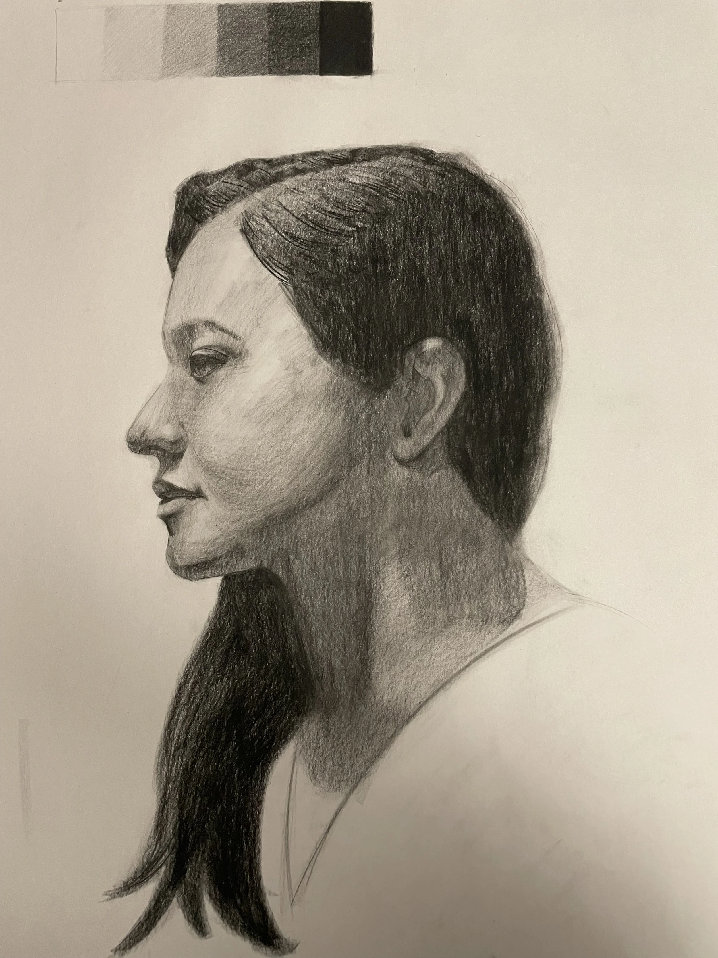 A detailed pencil sketch of a woman in profile with short, dark hair, facing left. The sketch emphasizes facial features, hair texture, and shading for depth.