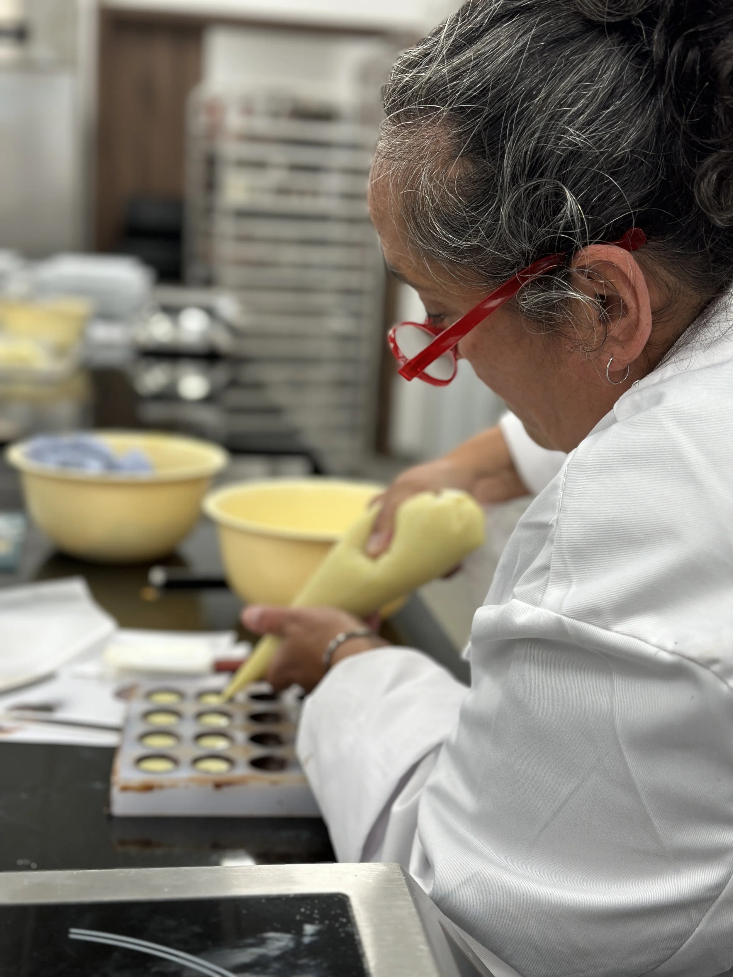 Laura learning professional chocolate-making techniques during her chocolatier training course.