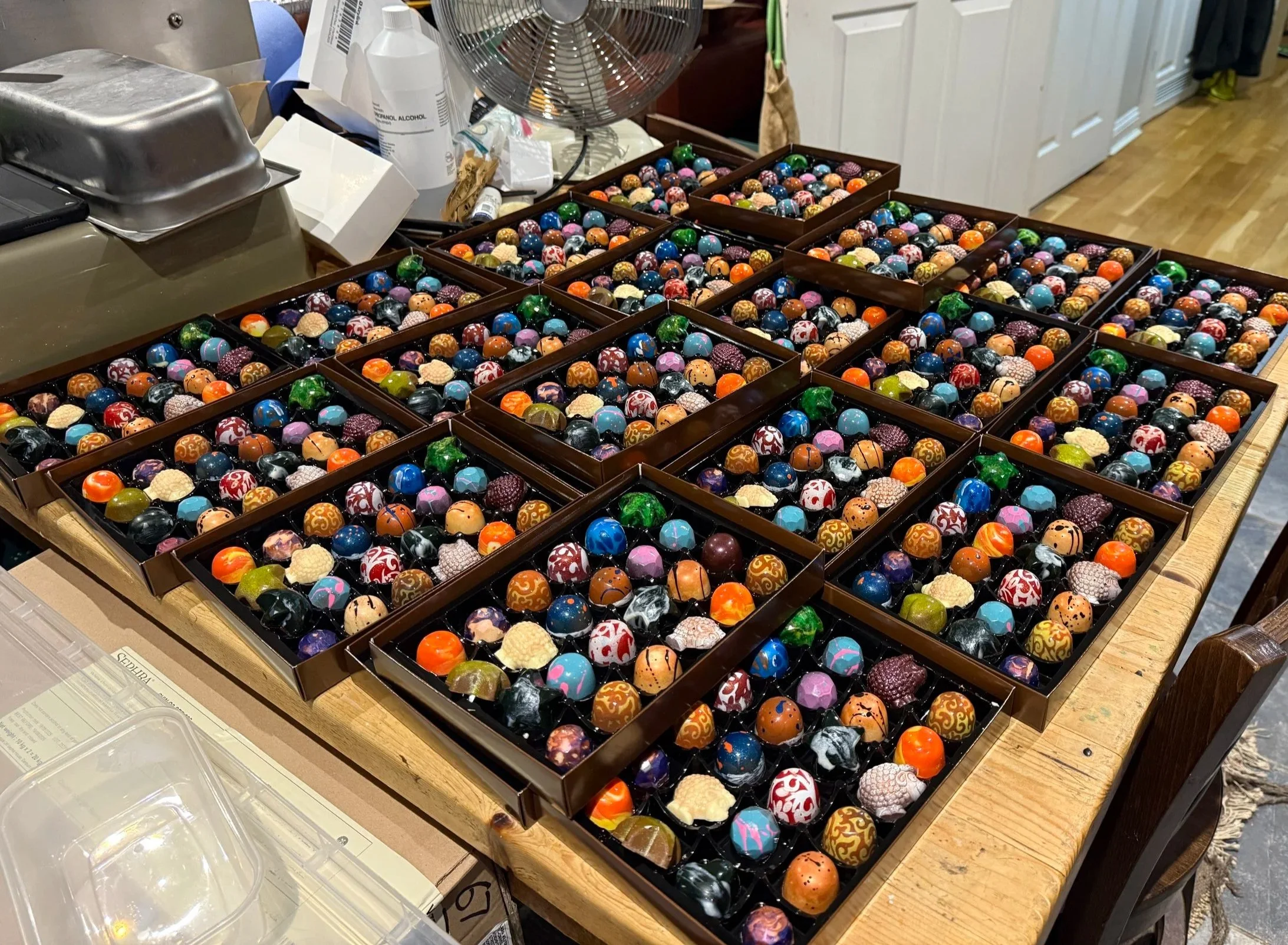 Boxes of hand-painted OzMo chocolates being packed and prepared for customers.