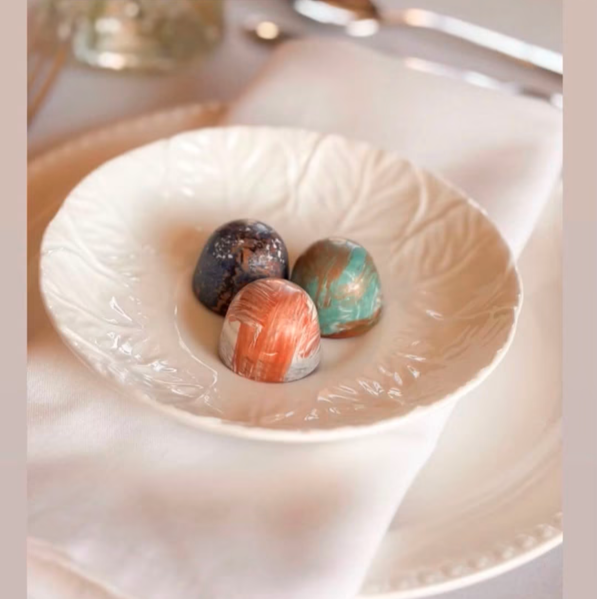 Styled wedding display featuring hand-painted OzMo chocolate bonbons by North Cadbury Court, Somerset.