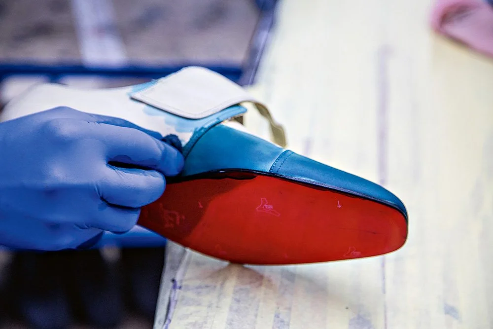 Italian artisan demonstrating luxury shoemaking craftsmanship at Christian Louboutin Naples factory