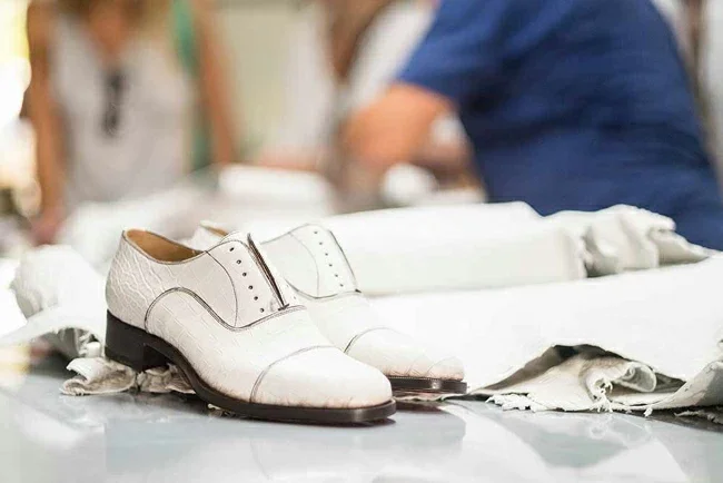 Italian artisan demonstrating luxury shoemaking craftsmanship at Christian Louboutin Naples factory