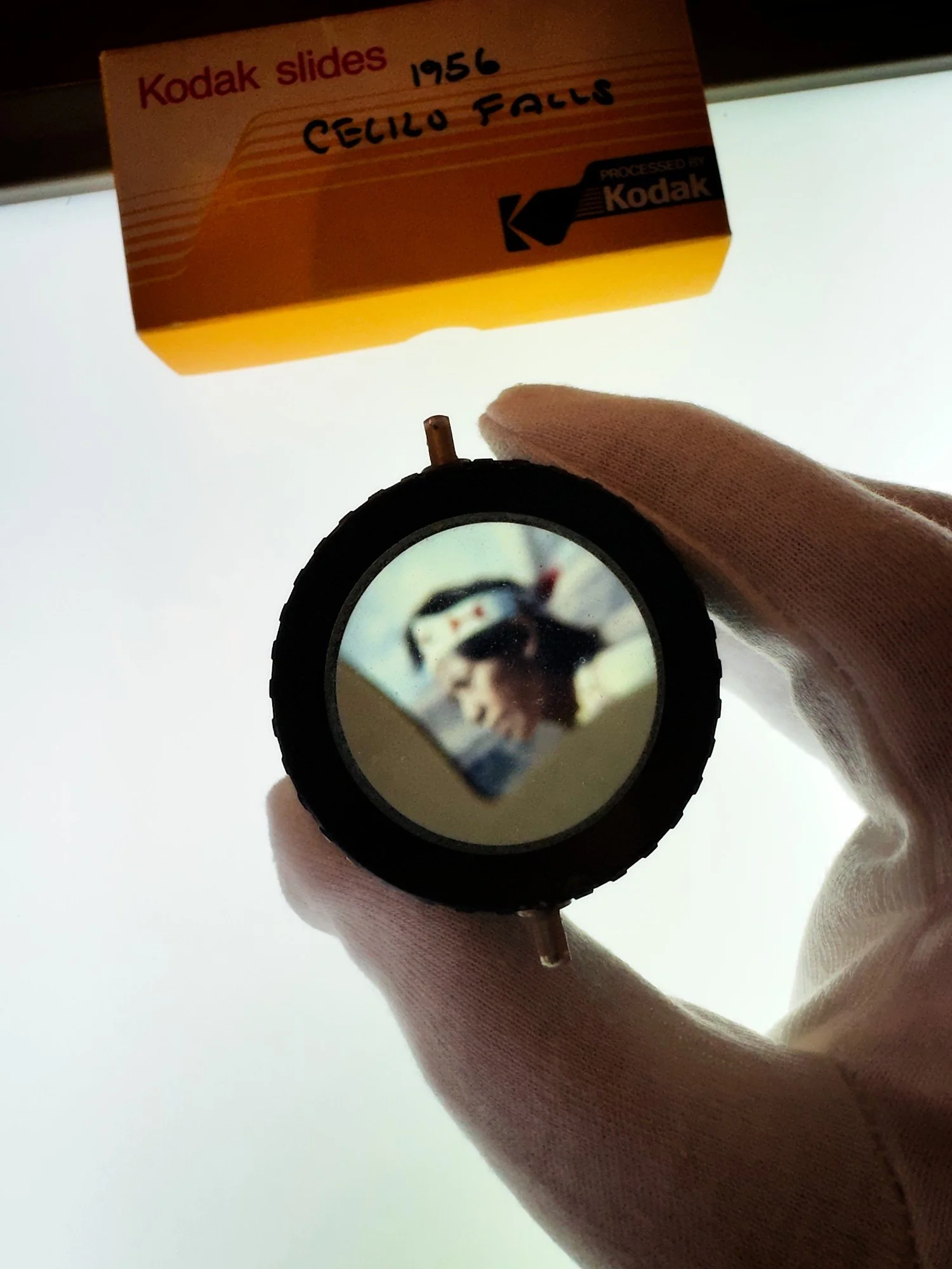 LIght table with color slides and a loupe magnifying a slide