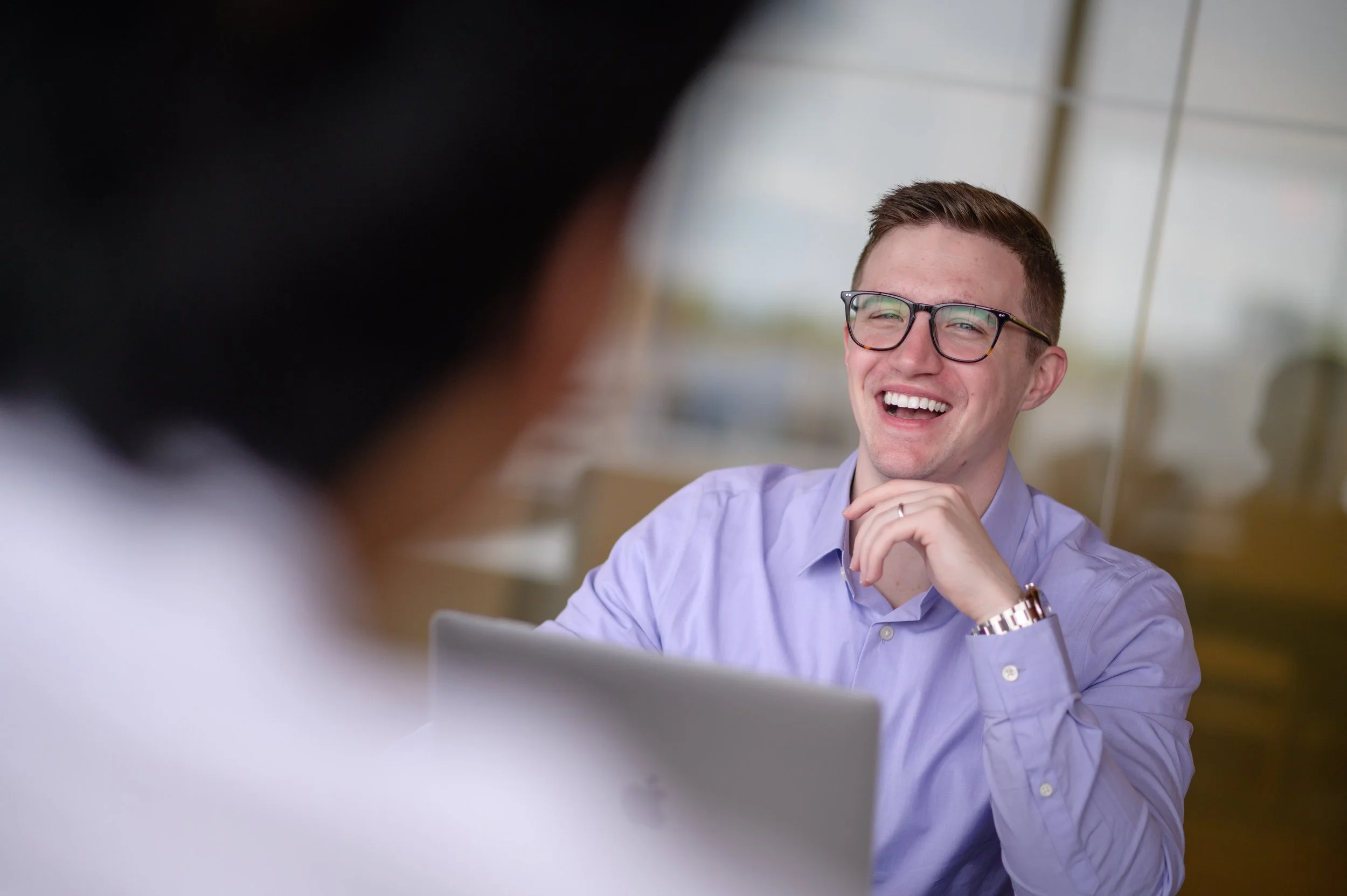 Thomas J. Fewer, Assistant Professor at Rutgers University, smiling in a modern office environment.