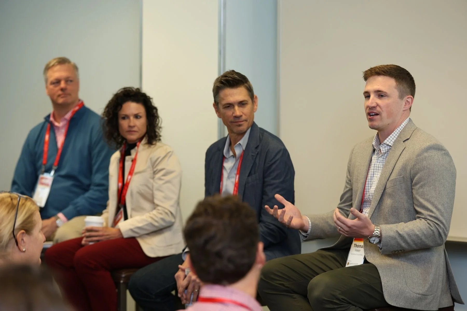 Thomas J. Fewer speaking during a panel discussion on leadership, innovation, and societal impact.