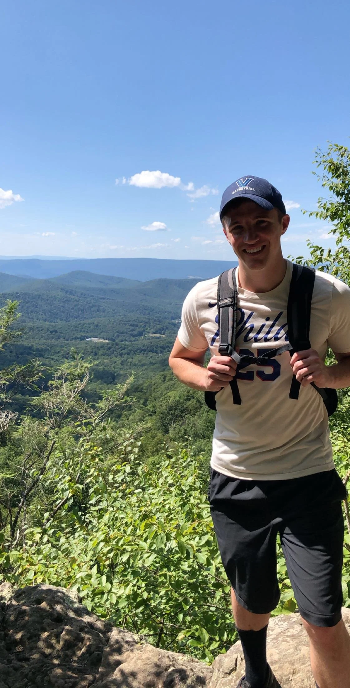 Thomas J. Fewer hiking a mountain during a research break academic conference.