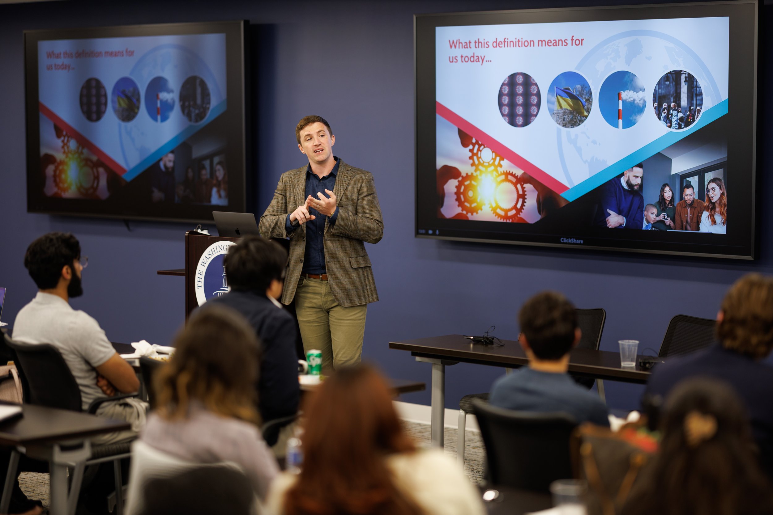 Thomas J. Fewer presenting research on organizations, politics, and public impact at an academic conference at Drexel University