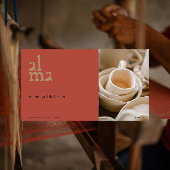 Brand Guidelines document titled 'Alma' with an image of pottery on the cover, placed on a table with hands clasped nearby.
