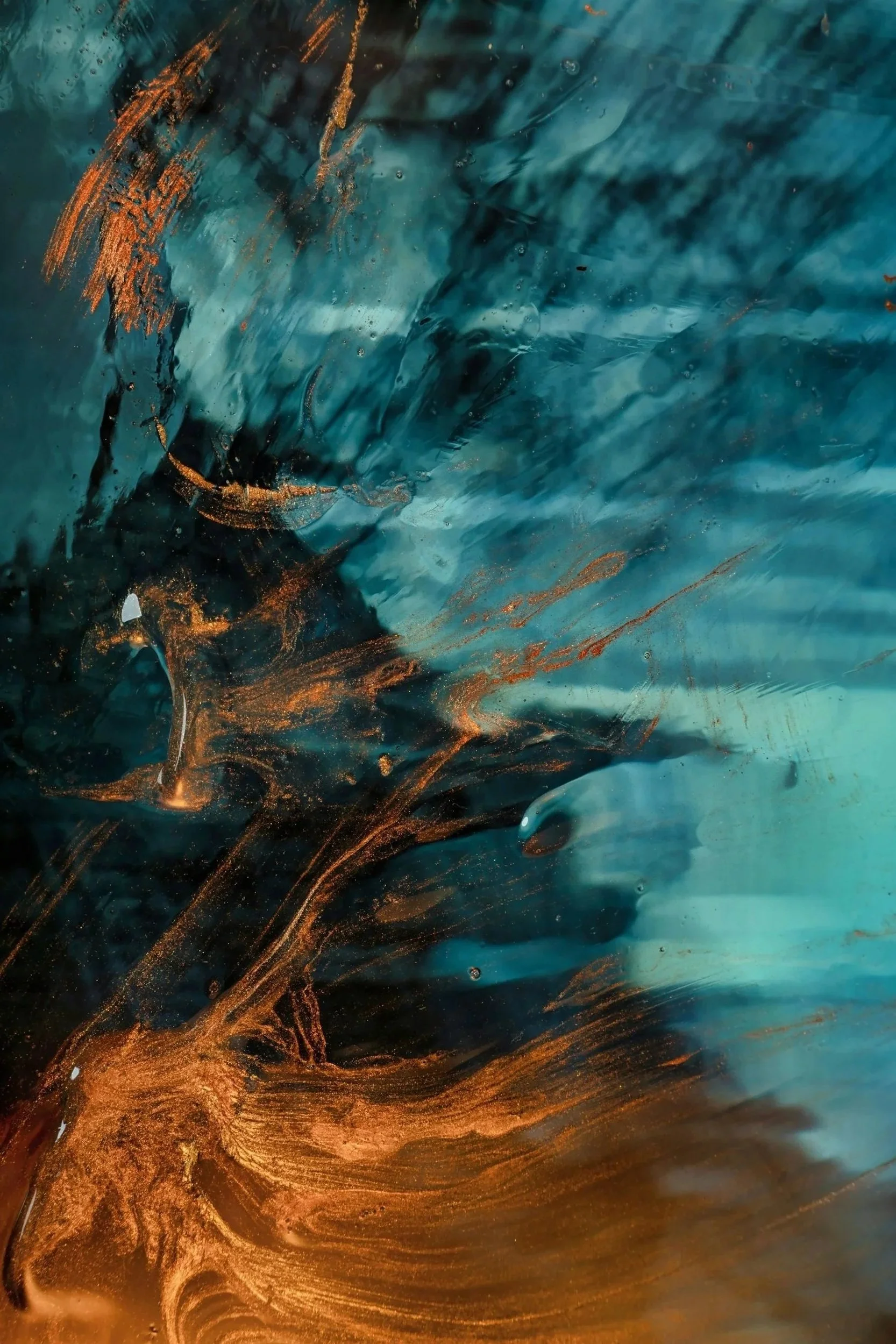 Abstract background featuring swirling blue, black, and copper-colored paint with dynamic textures and fluid motion.