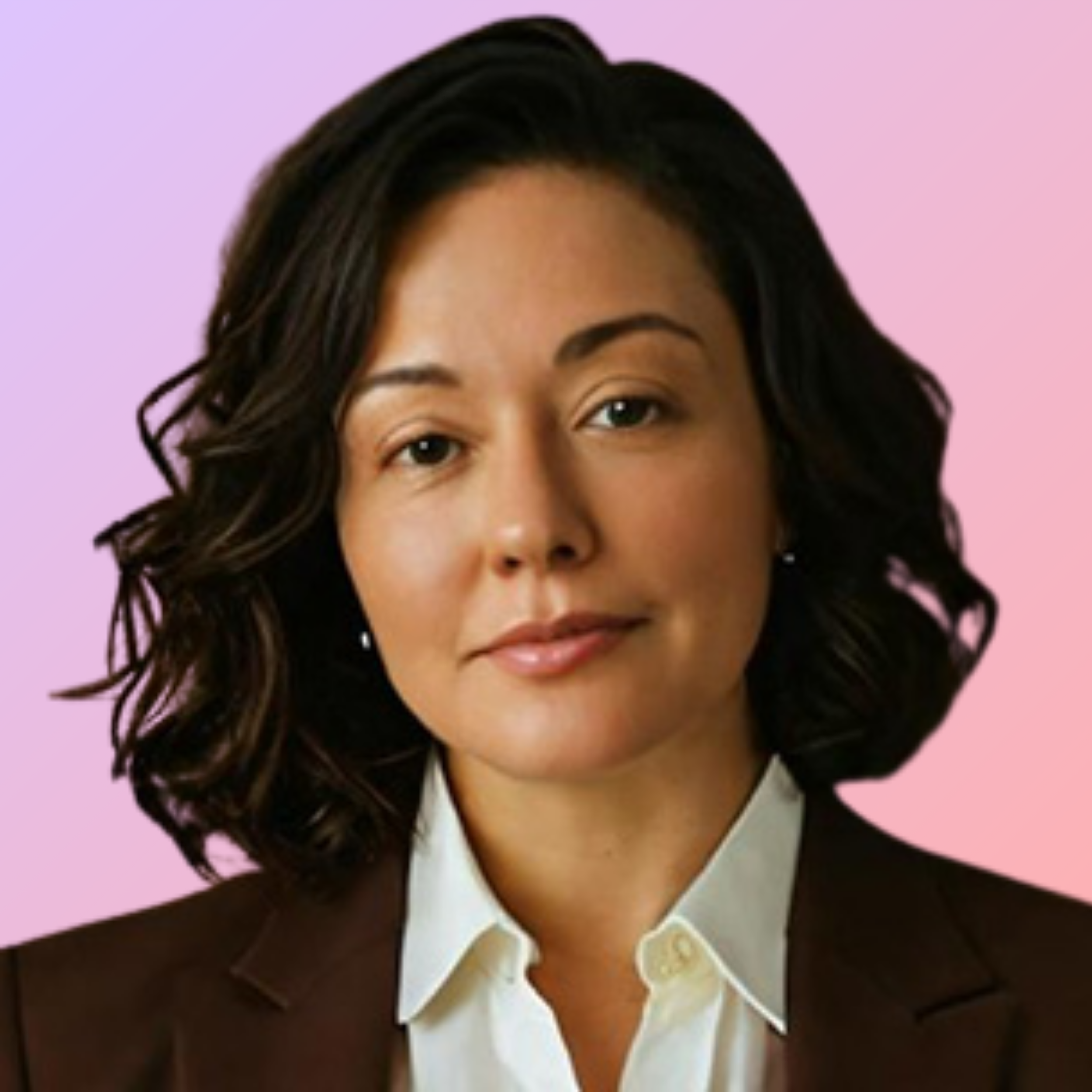 Close-up portrait of a woman with shoulder-length dark wavy hair, wearing a white shirt and a dark blazer, against a peach and purple gradient background.