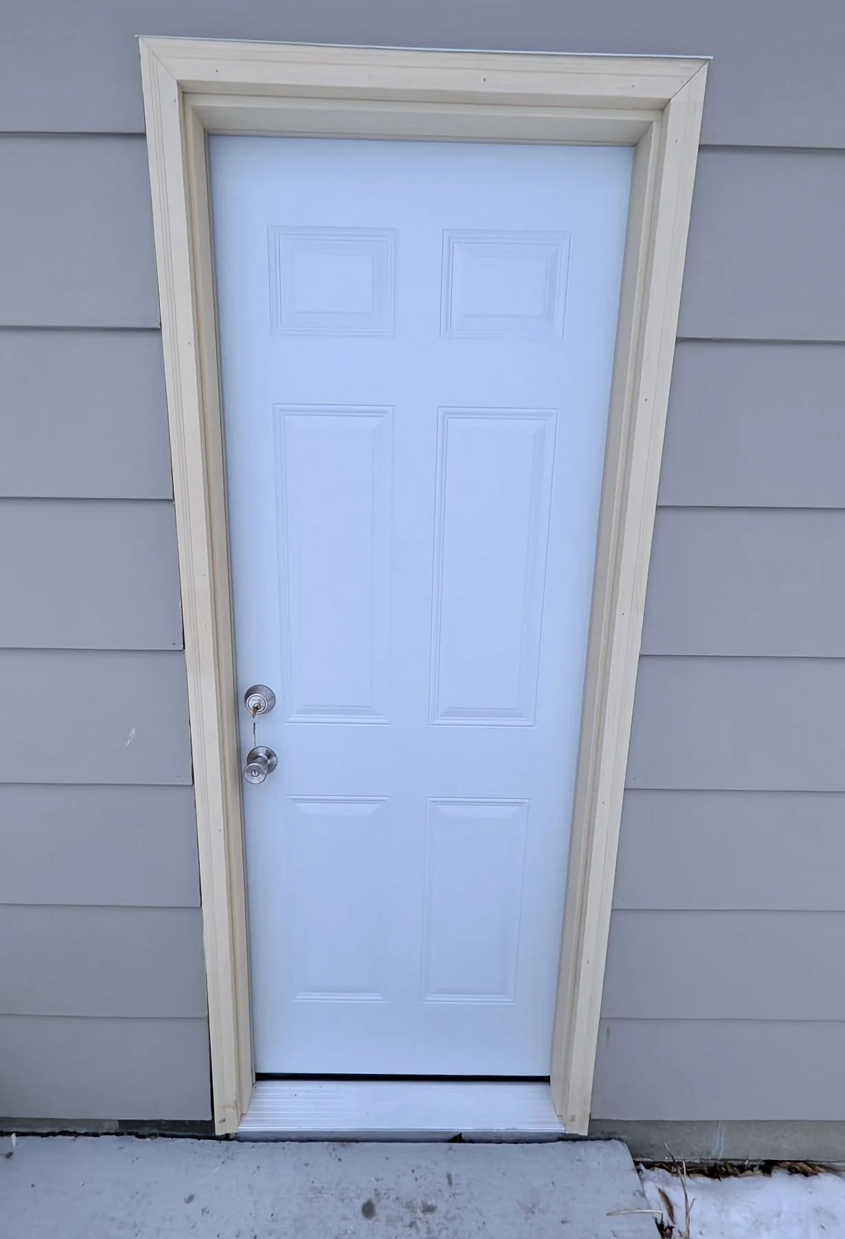 New exterior doors installed with updated trim, hardware, and thresholds. Ready for homeowner painting.