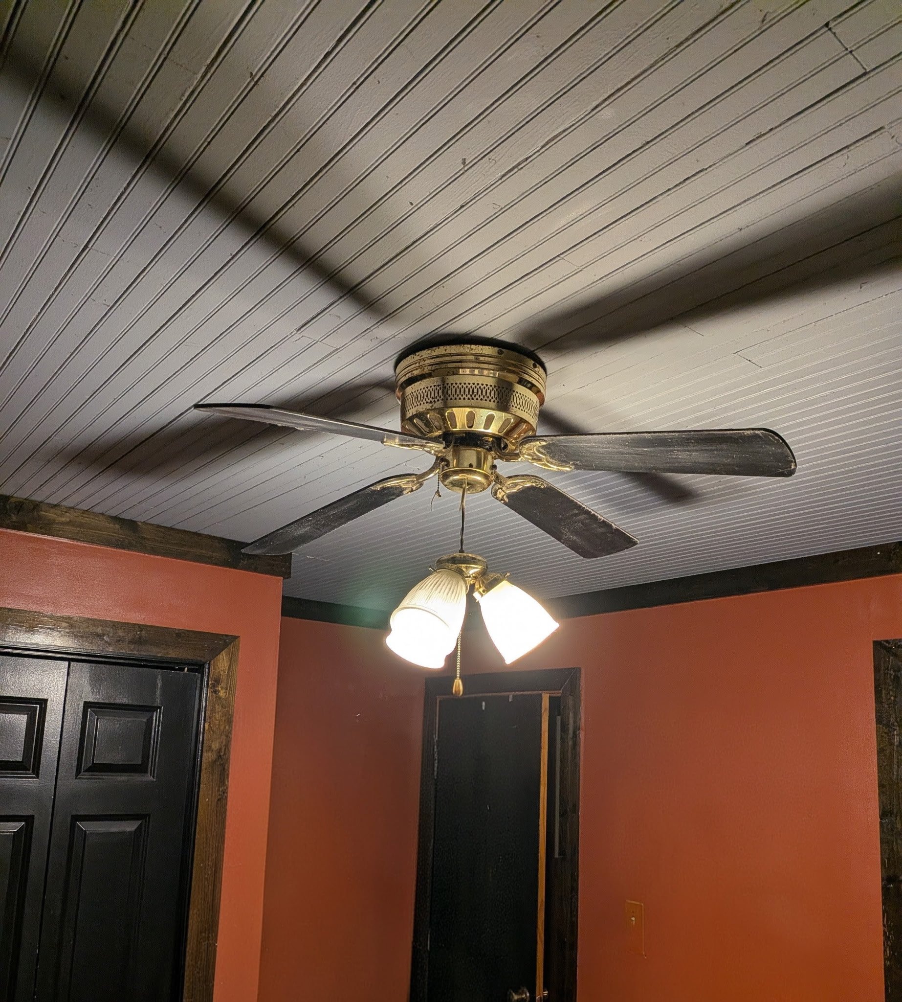 BEFORE: Outdated ceiling fan with limited airflow and dated lighting, no longer fitting the space or providing optimal performance.