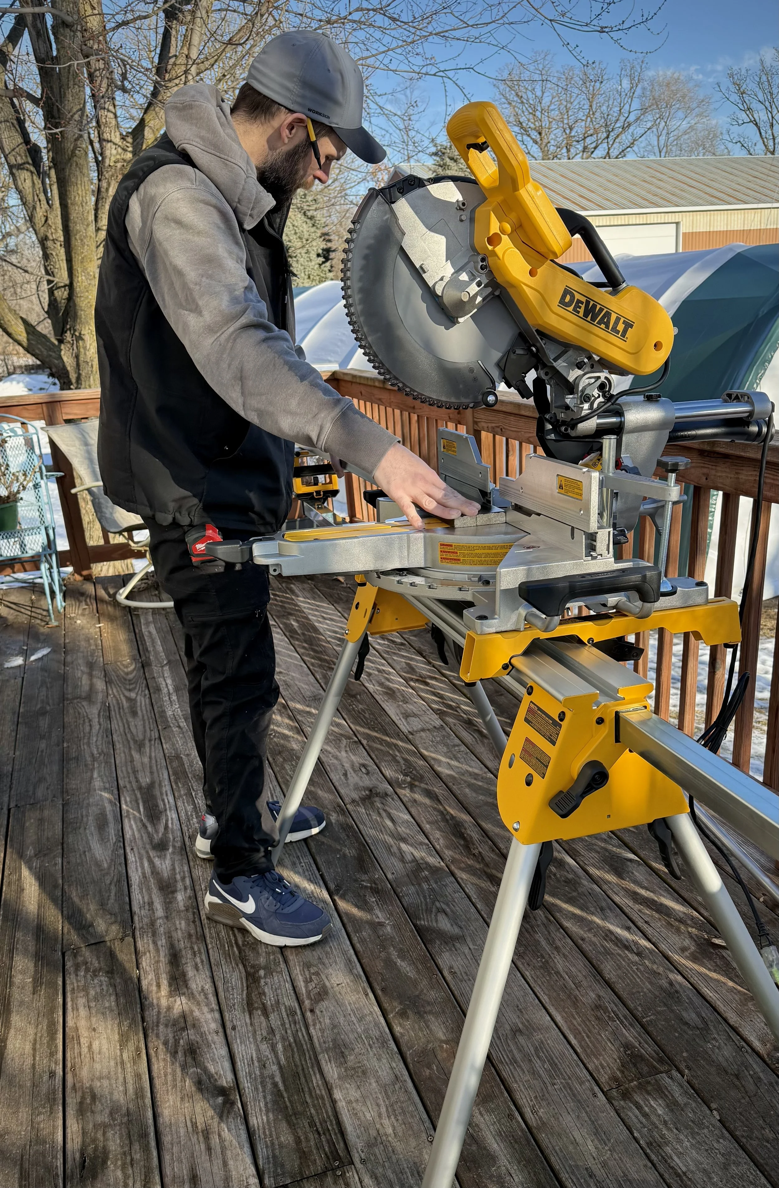 Handyman, window installer and door installer completing finish carpentry work using a miter saw in Lonsdale, Minnesota