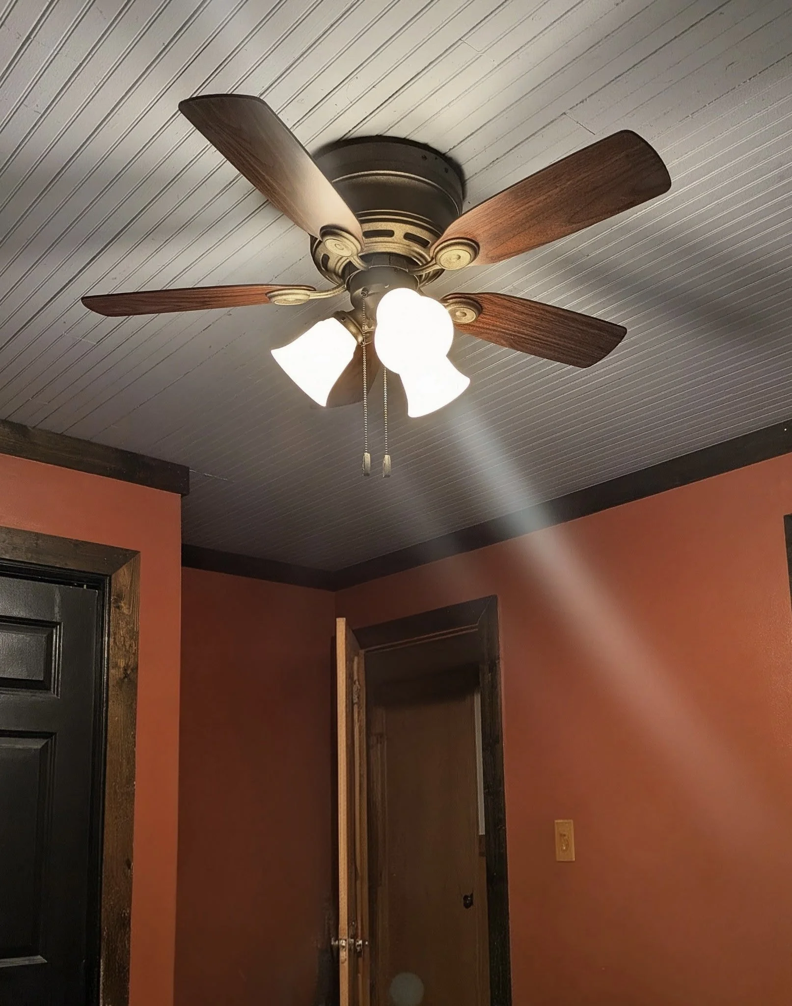 AFTER: Installed and updated ceiling fan with improved airflow and refreshed lighting, enhancing both comfort and the overall look of the room.