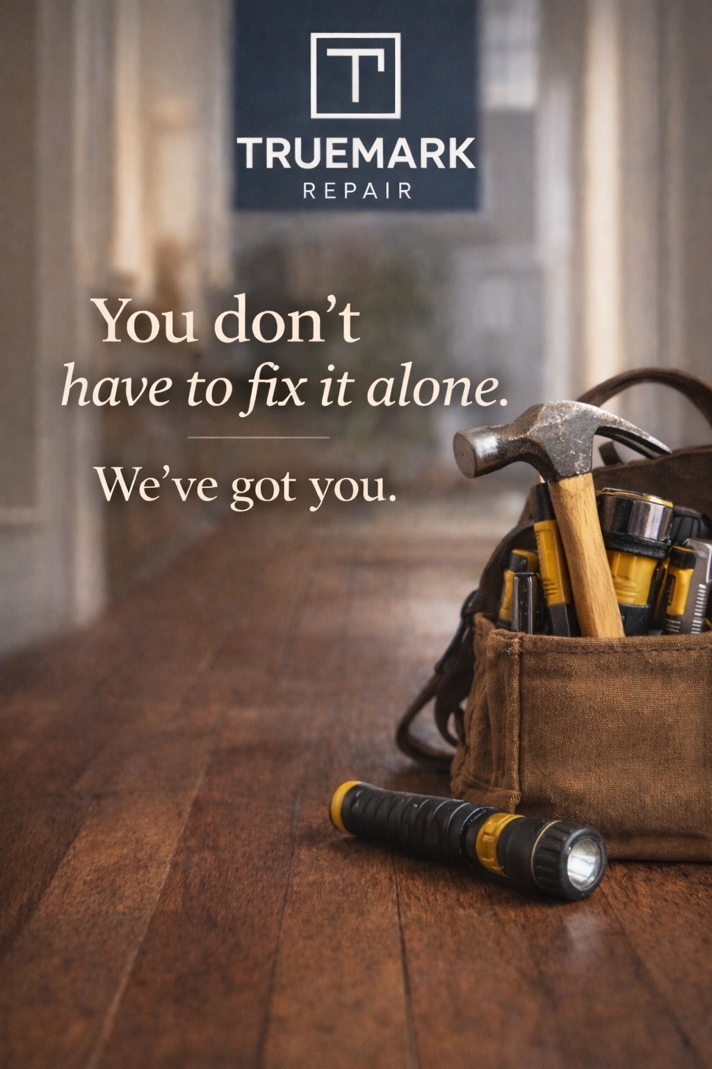 A toolbox with a hammer, a flashlight, and other tools on a wooden floor, with a sign in the background that reads "TRUEMARK REPAIR." Text on the image says, "You don't have to fix it alone. We've got you."