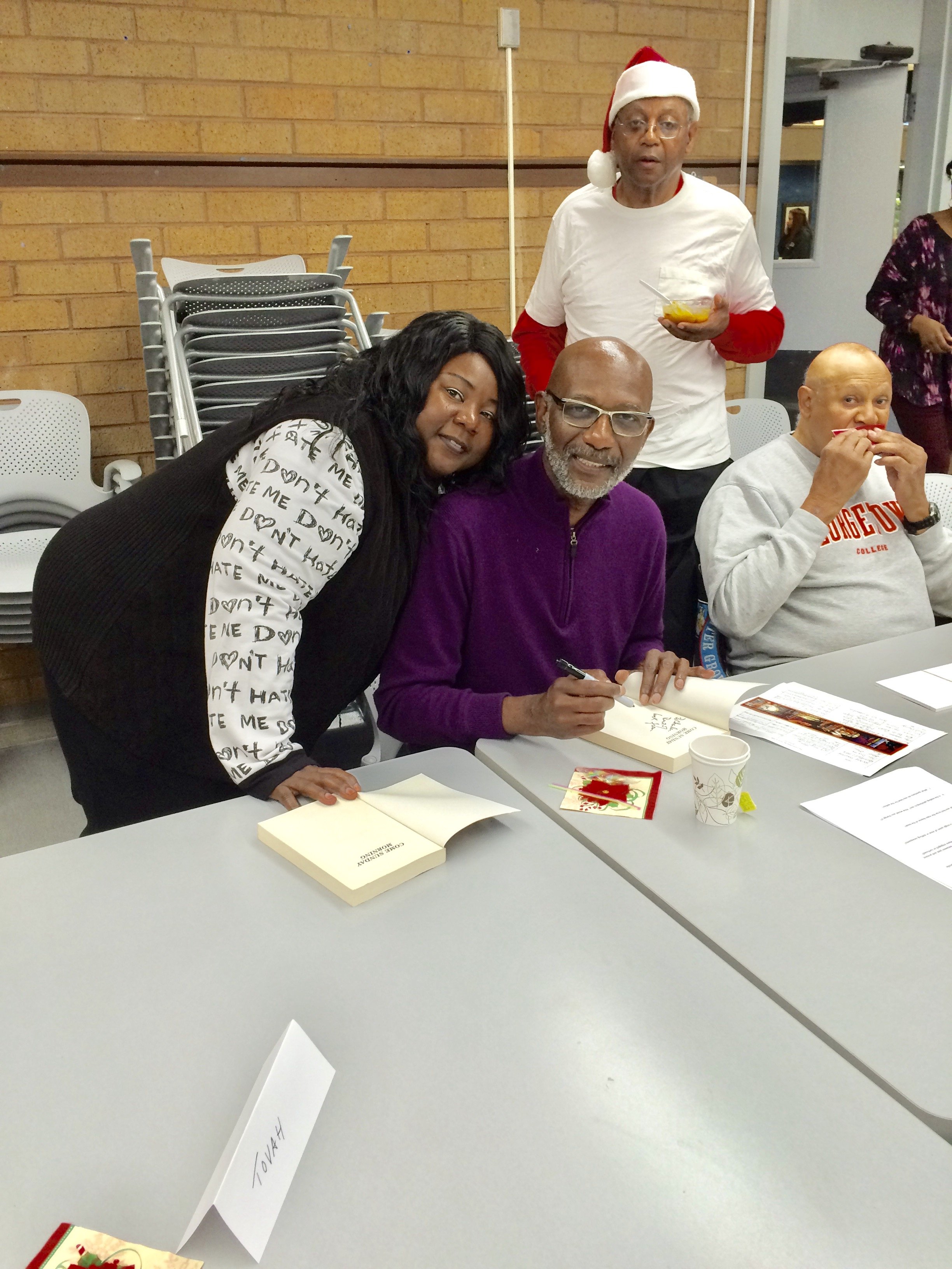 Terry Hill with fans at a book signing in Oakland