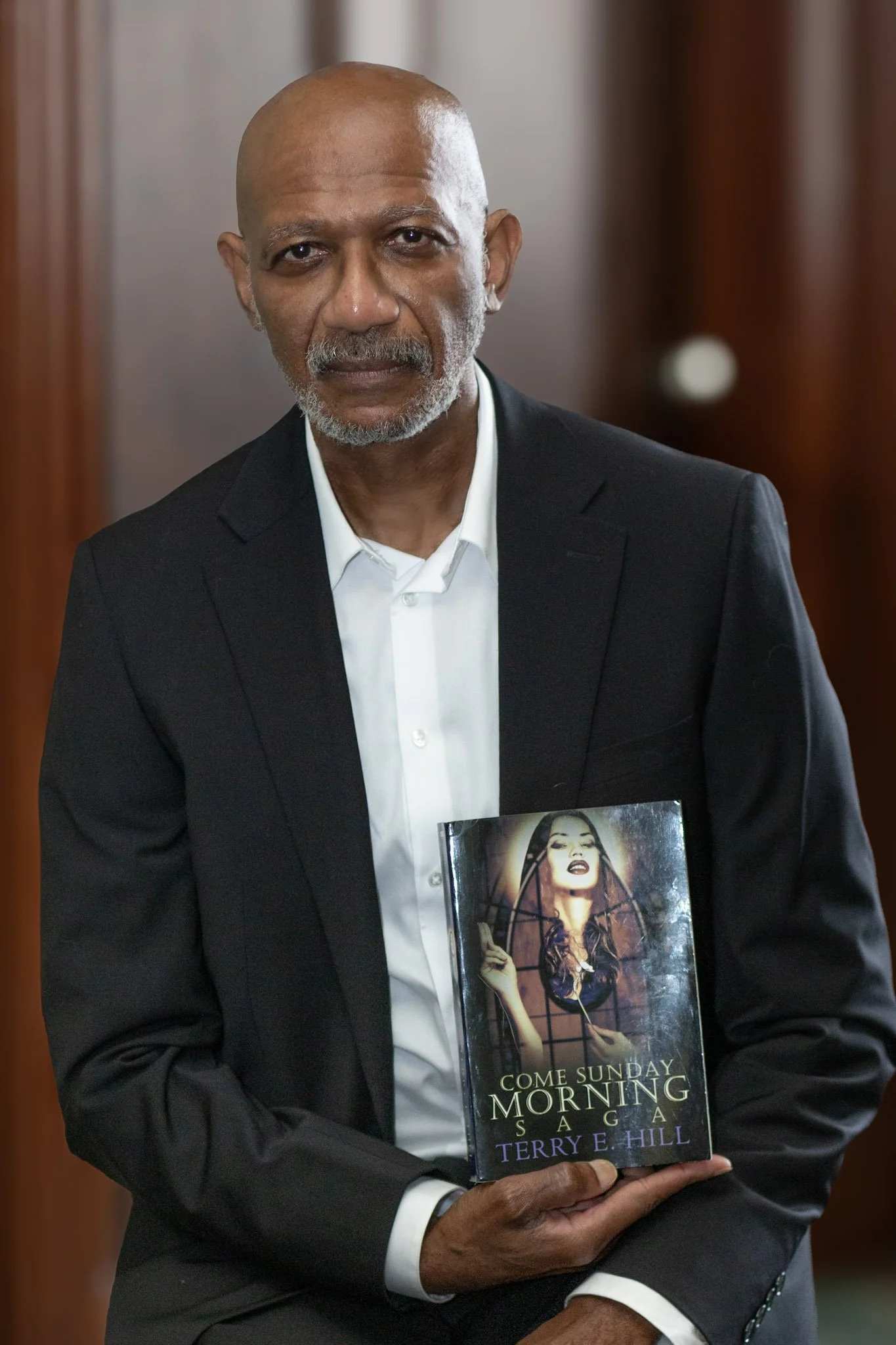 Terry taking a picture with his book