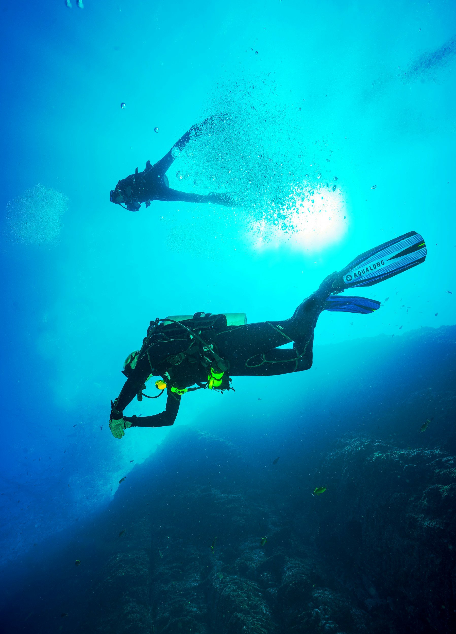 Scuba divers exploring the clear blue water in Cyprus.