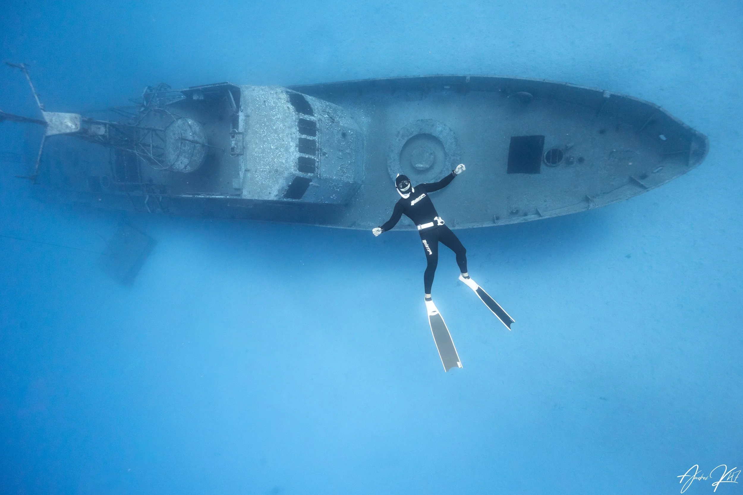 A freediver gliding above the Kyrenia shipwreck in Protaras, Cyprus during a breath‑hold dive.