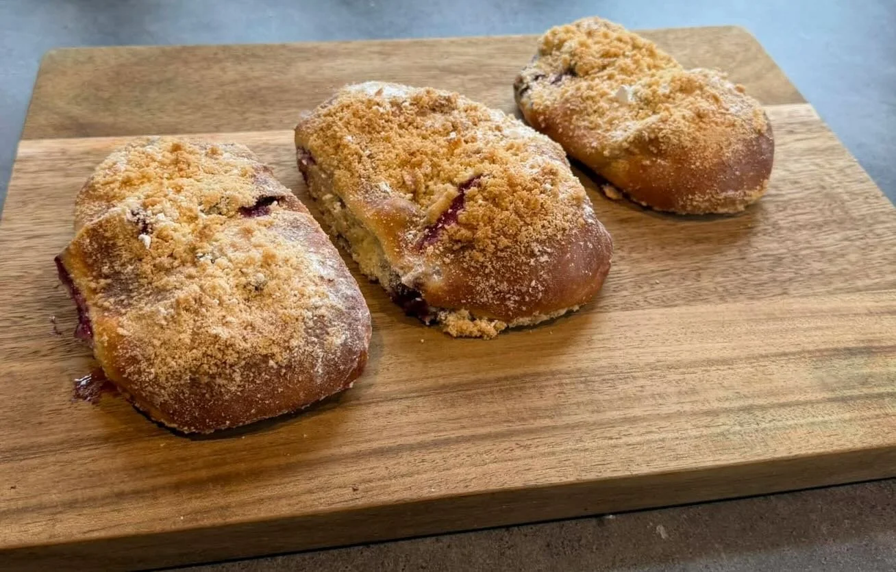 ✨A little bakery magic ✨

Meet *jagodzianki* &mdash; golden cloud buns hiding a jammy midnight secret.

Break one open and 💜 spills out like a summer fairytale.

Sticky fingers. Powdered sugar snow.
Proof that happiness can fit in the palm of your h