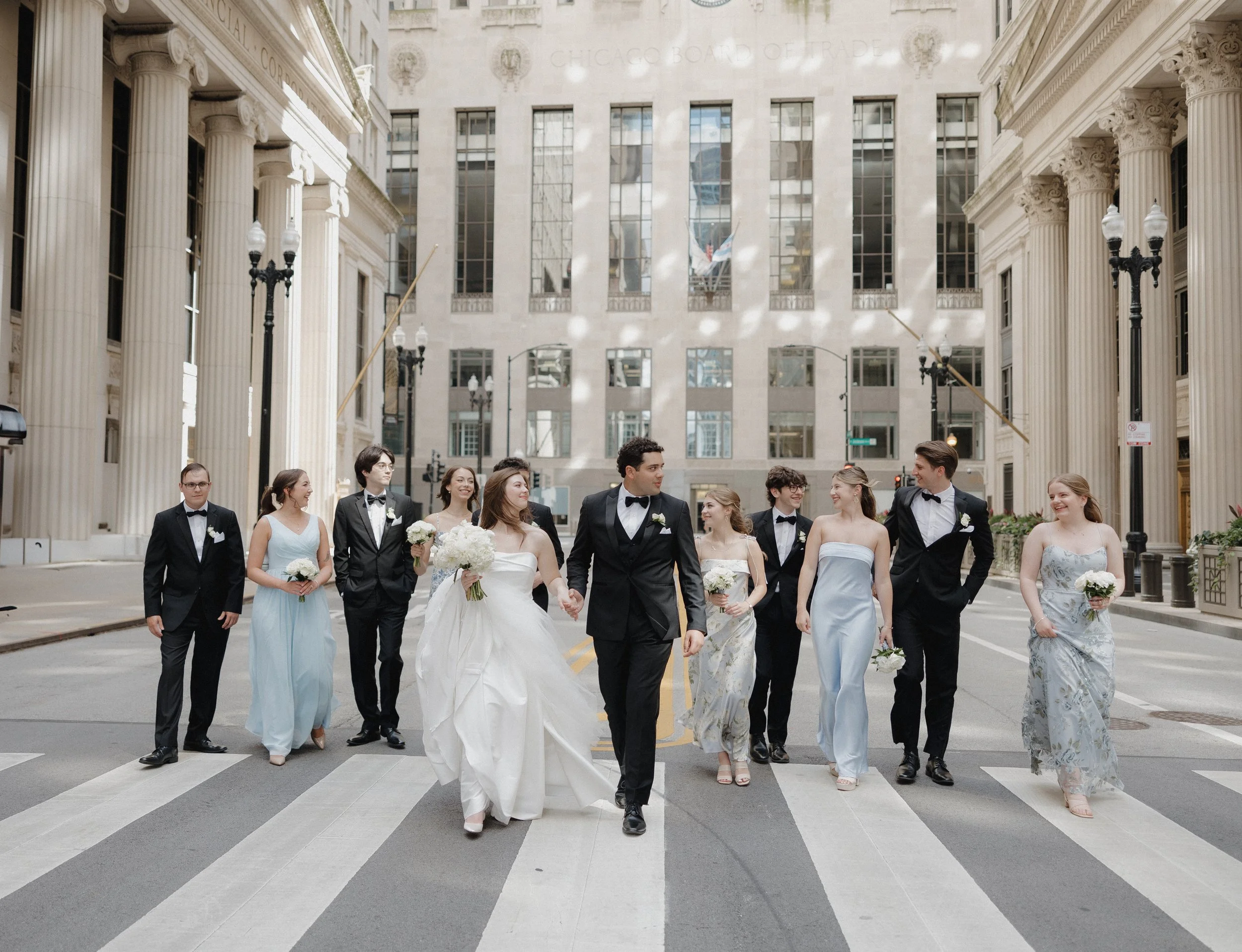 Wedding party walking and looking at eachother 