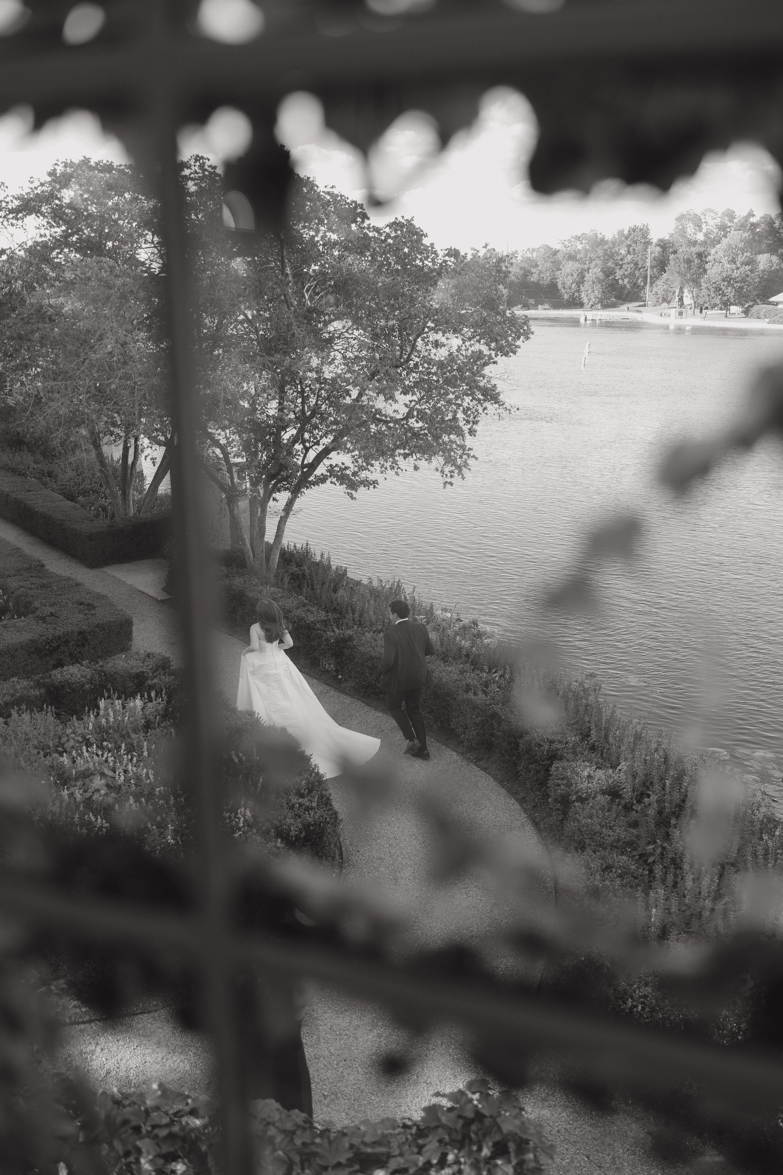 Bride and groom running through the graden with a shot from above  