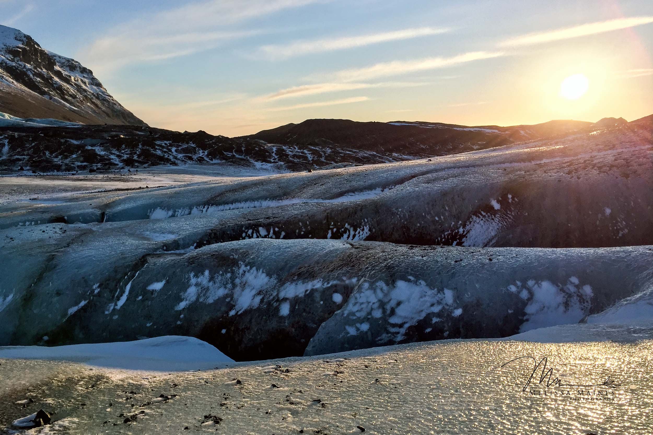An Icelandic glacier landscape at sunset with snow-covered ground 