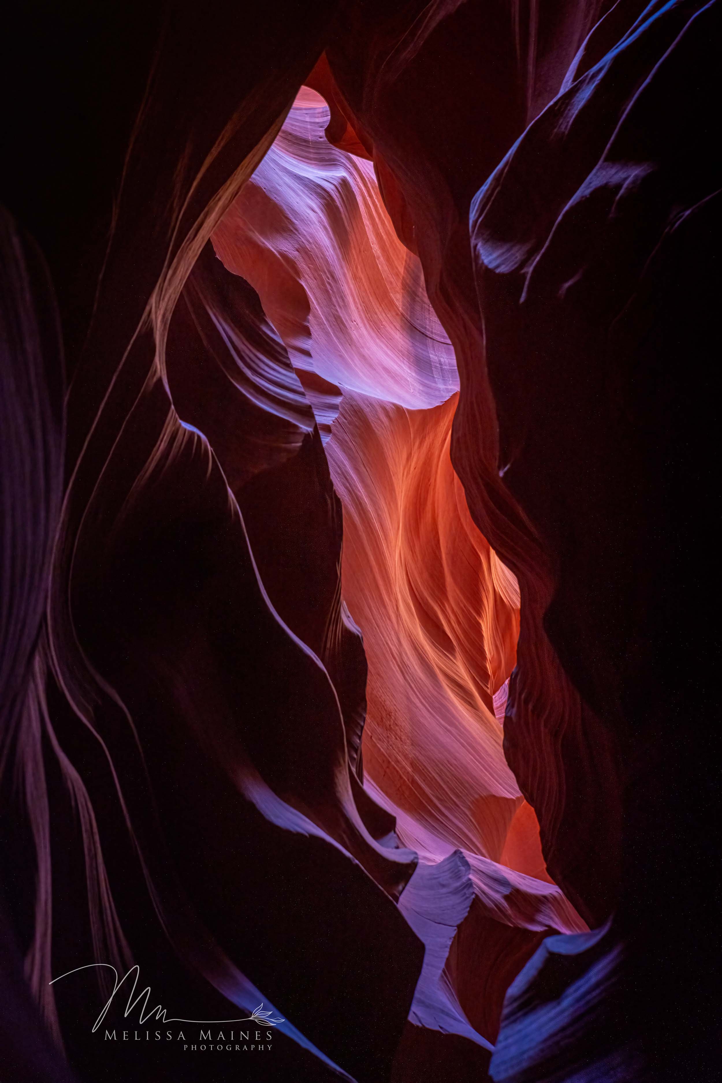Colorful Northern Antelope canyon with rock formations in shades of red, orange, pink, purple, and blue.
