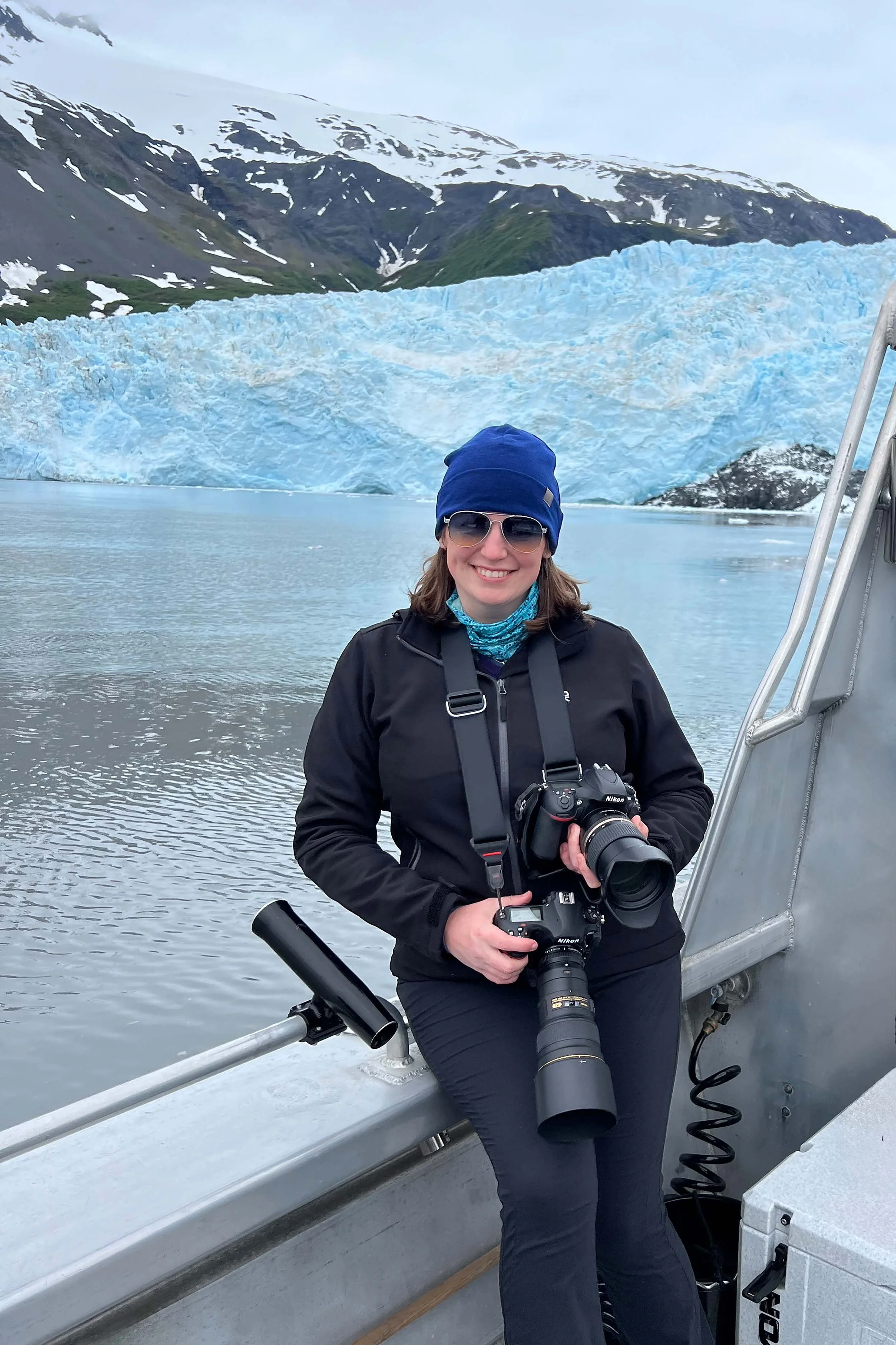 Photo of Melissa Maines in front of a glacier near Seward, Alaska.