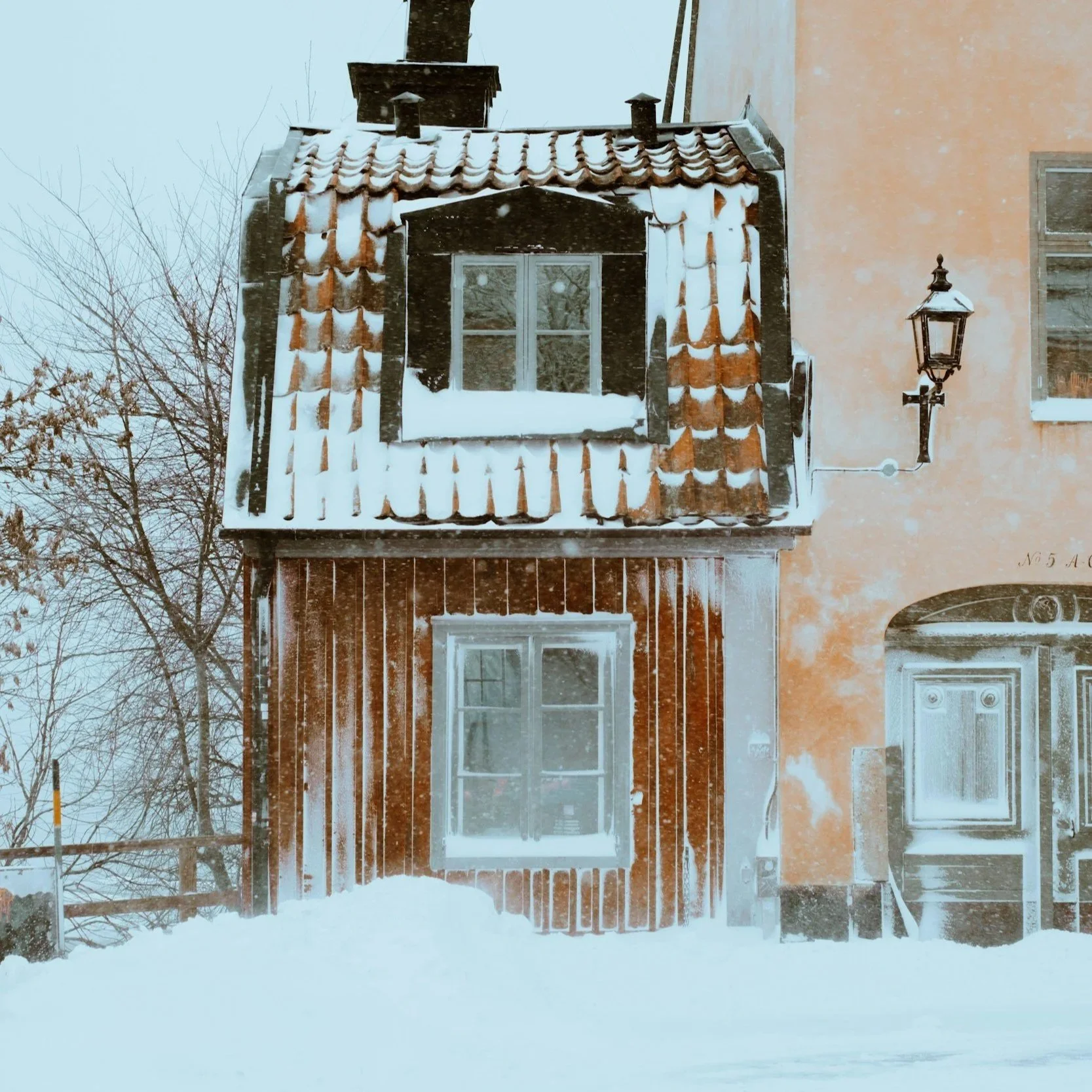 Wooden houses in Scandinavia with snow in the foreground
