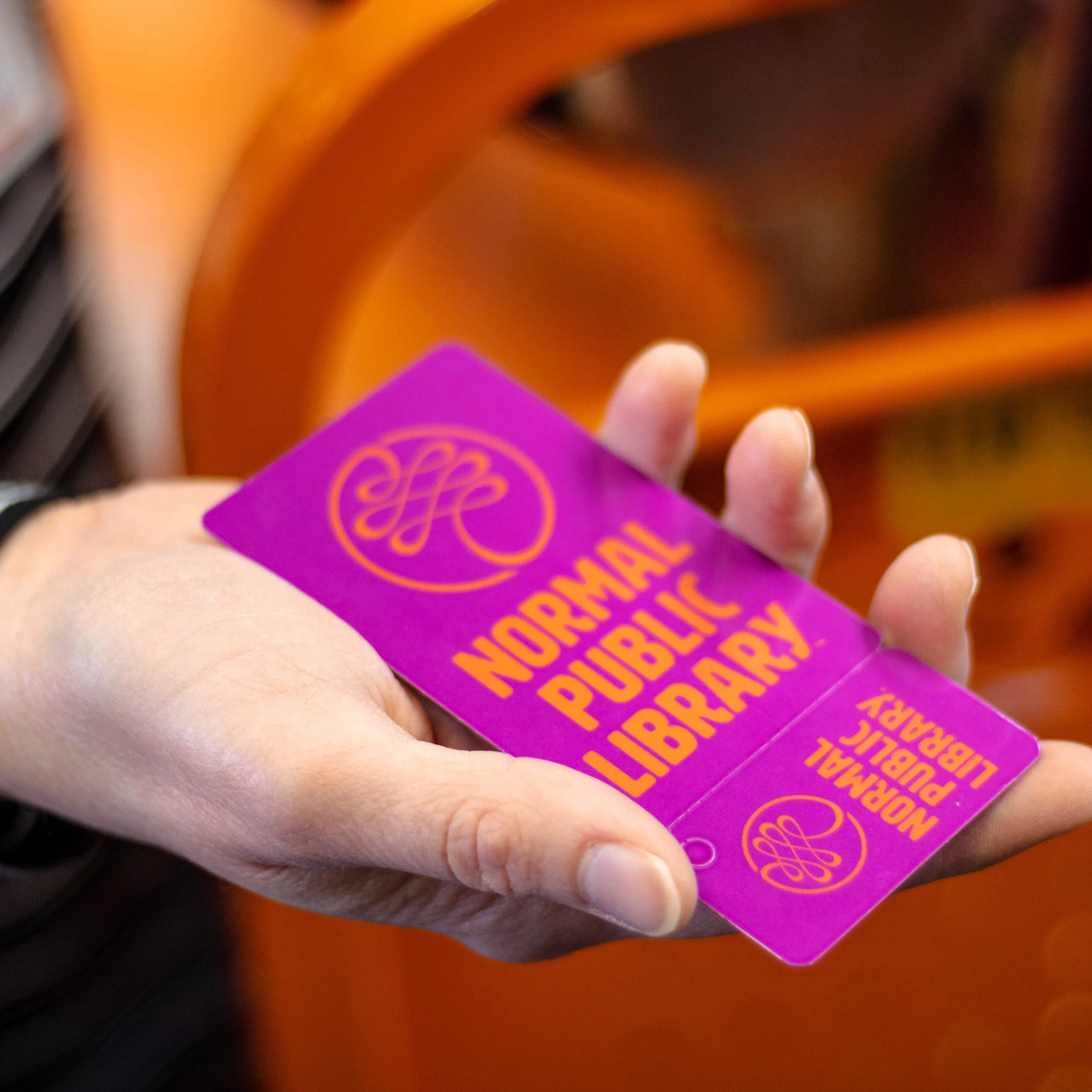 Hand holding a purple library card