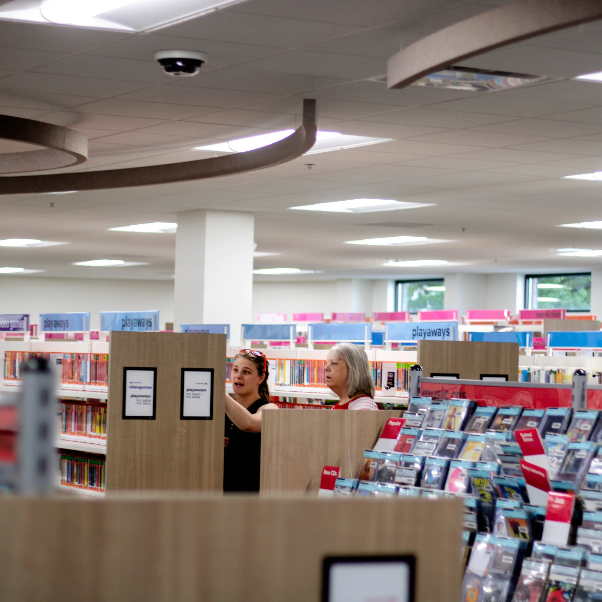 Two women browsing books in NPL