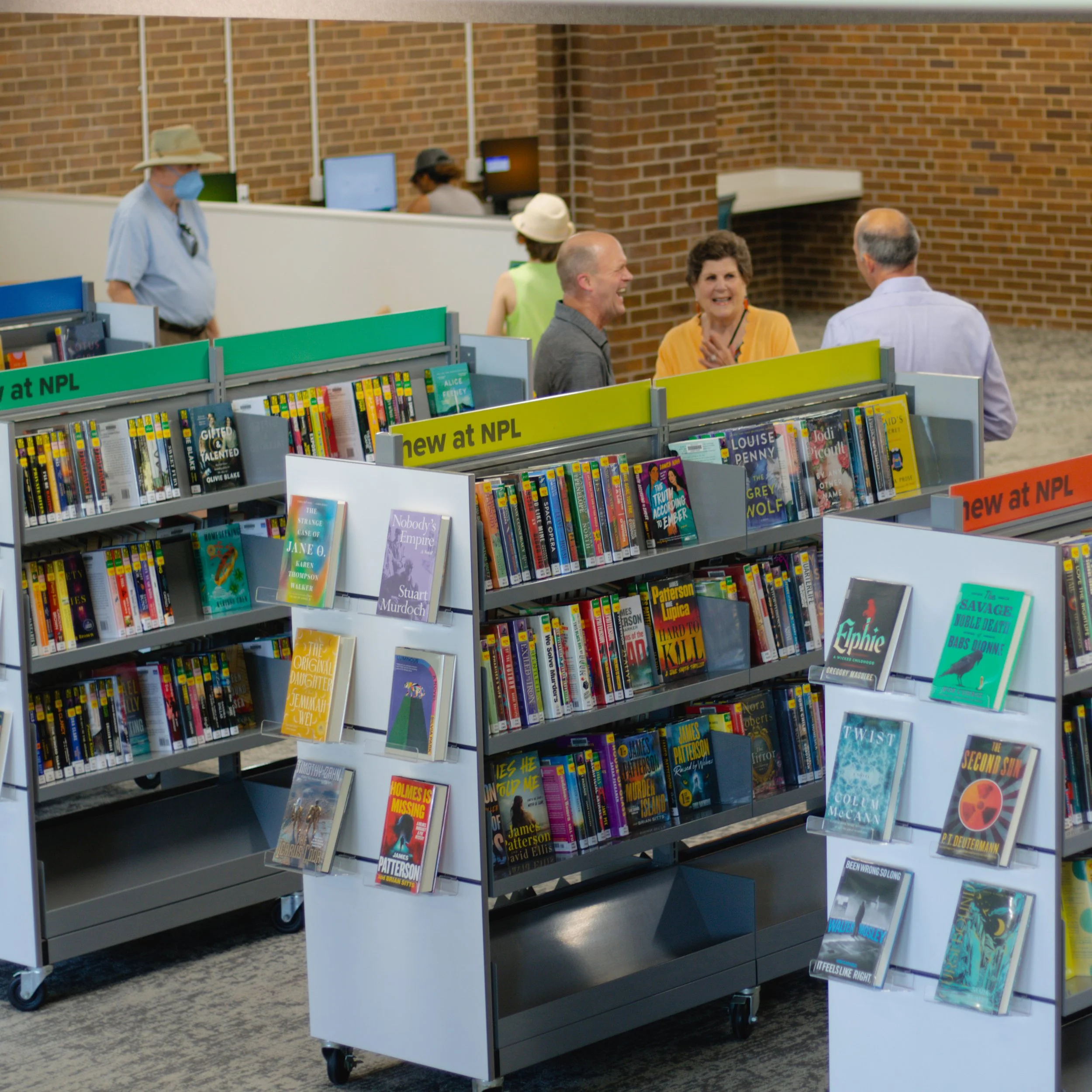 Book shelves and people chatting