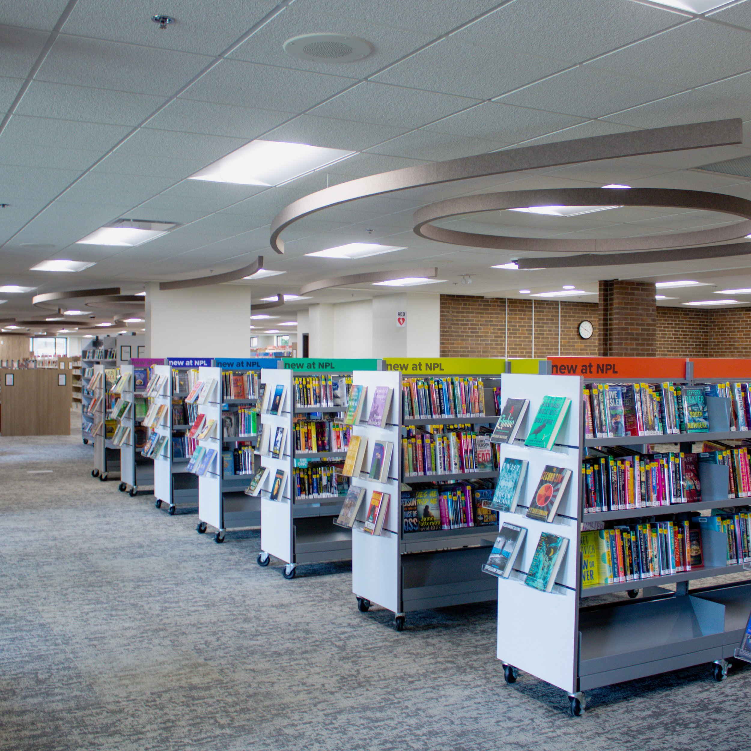 Line of bookshelves with multicolored signs