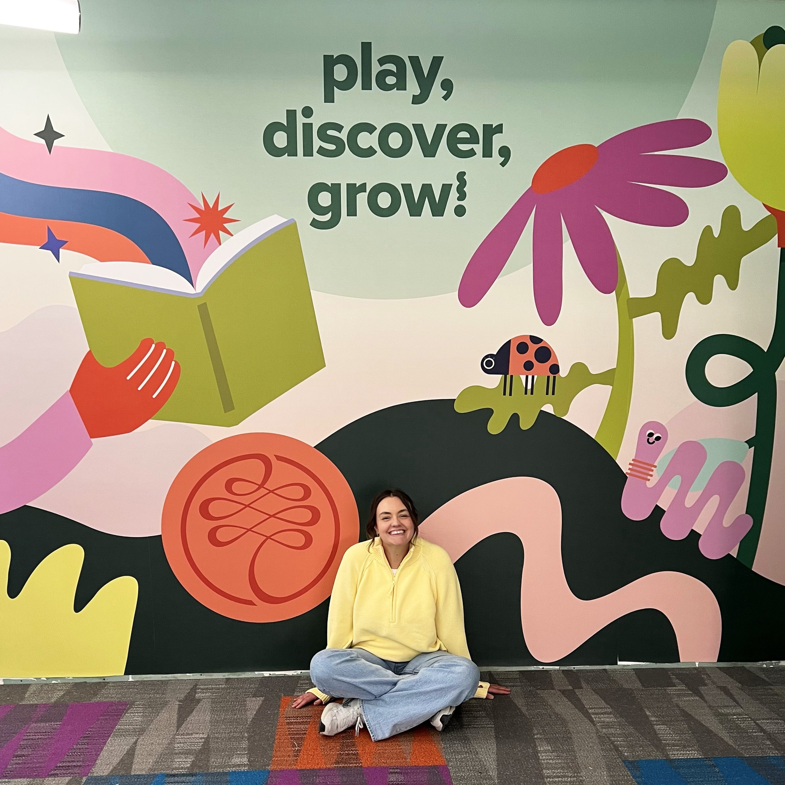 Designer in front of mural