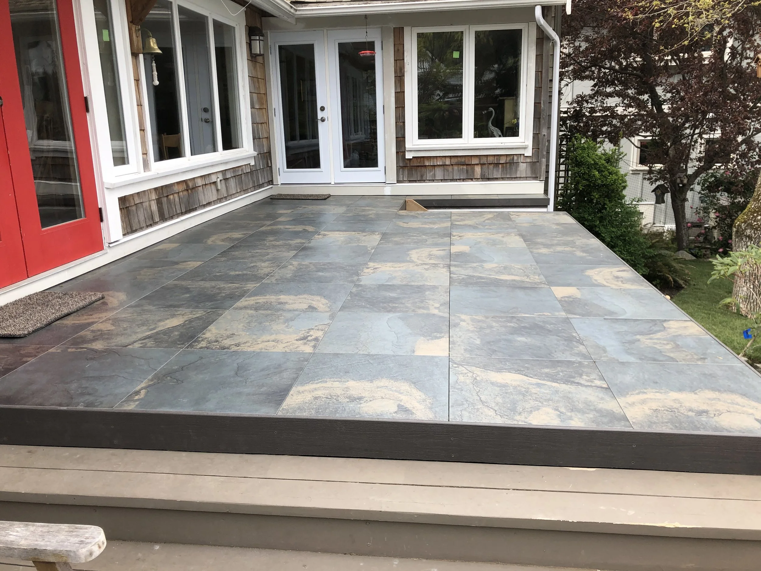 Outdoor Living Space
This custom-built patio features large-format stone tiles with rich natural variation, creating a durable and elegant outdoor surface. Clean lines, integrated steps, and seamless transitions to the home provide both function and 