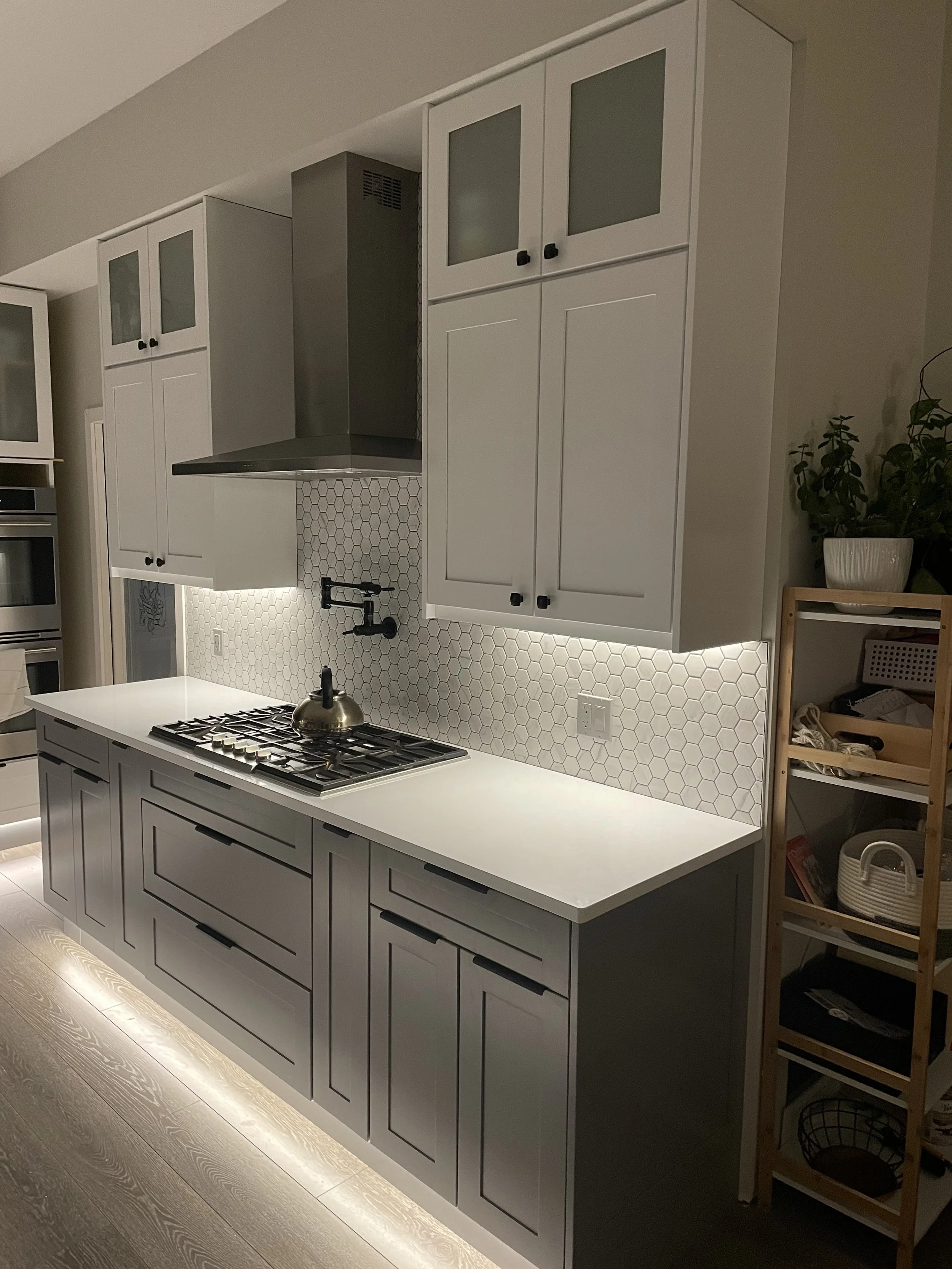 Modern Kitchen Remodel
A bright, contemporary kitchen with custom cabinetry, sleek hardware, and under-cabinet lighting that highlights a geometric tile backsplash. The space blends functionality and style with precision detailing, high-end finishes,