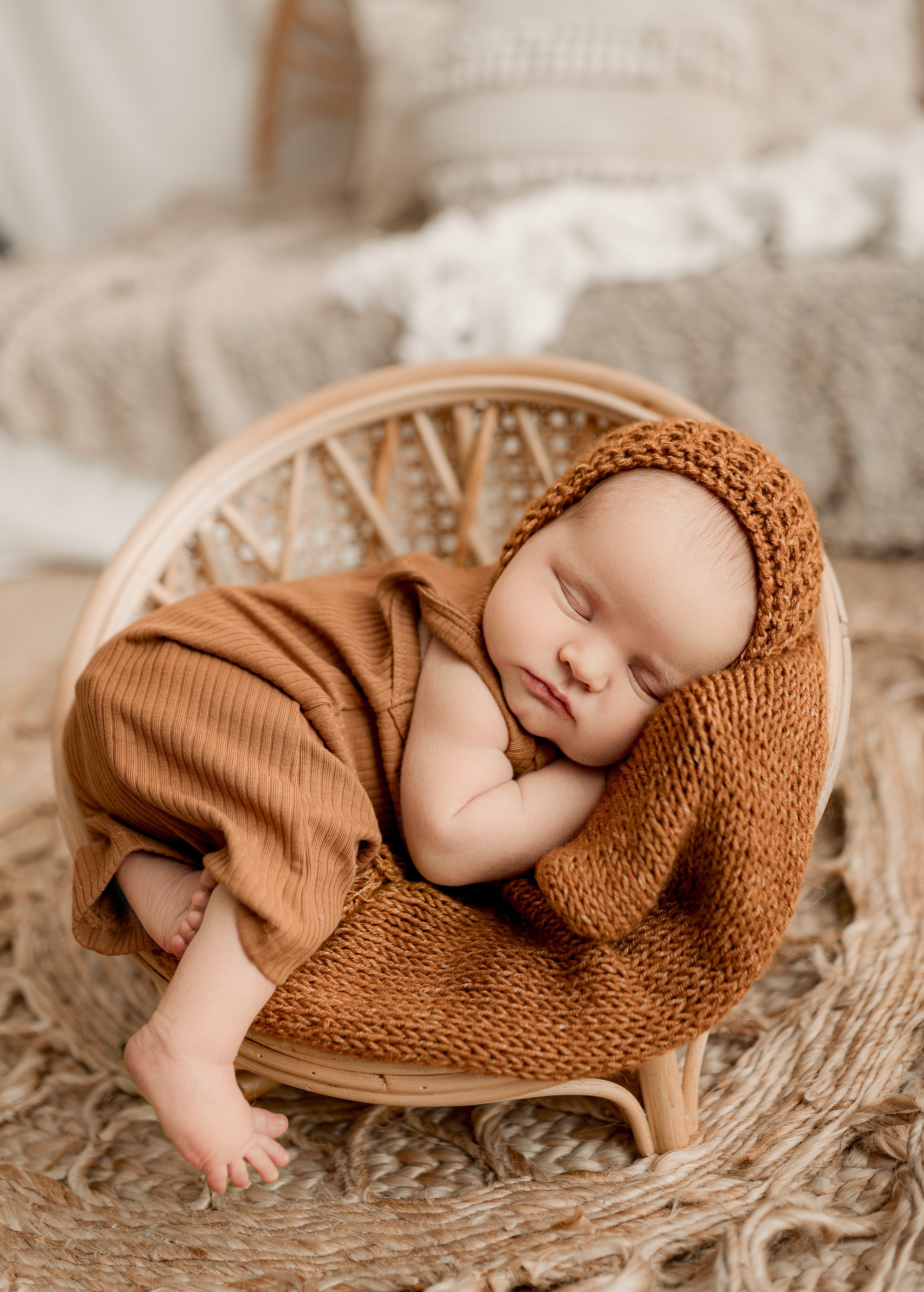 baby laying down on a wood bed in Round Rock studio