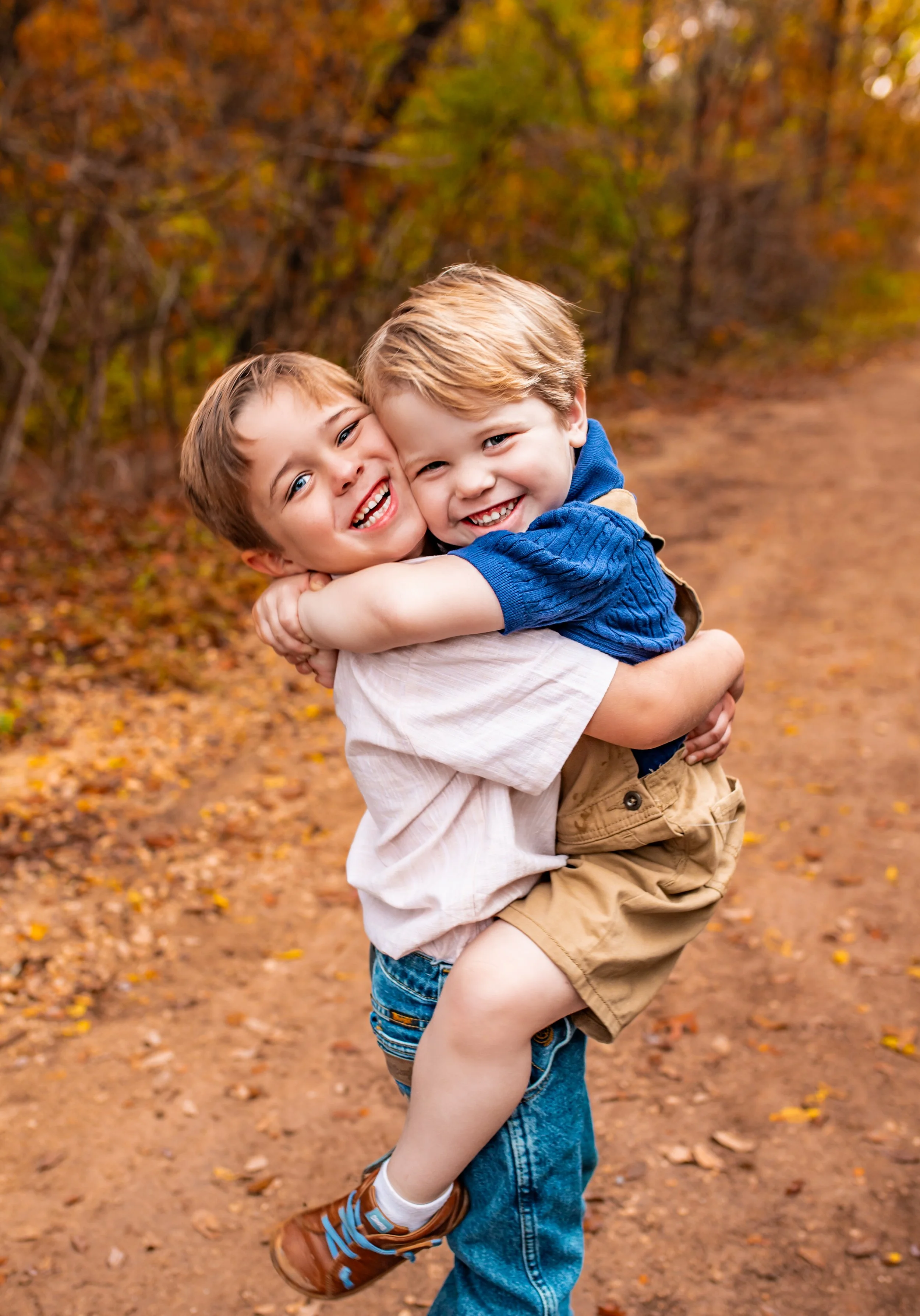 Siblings hugging during outdoor family photo session