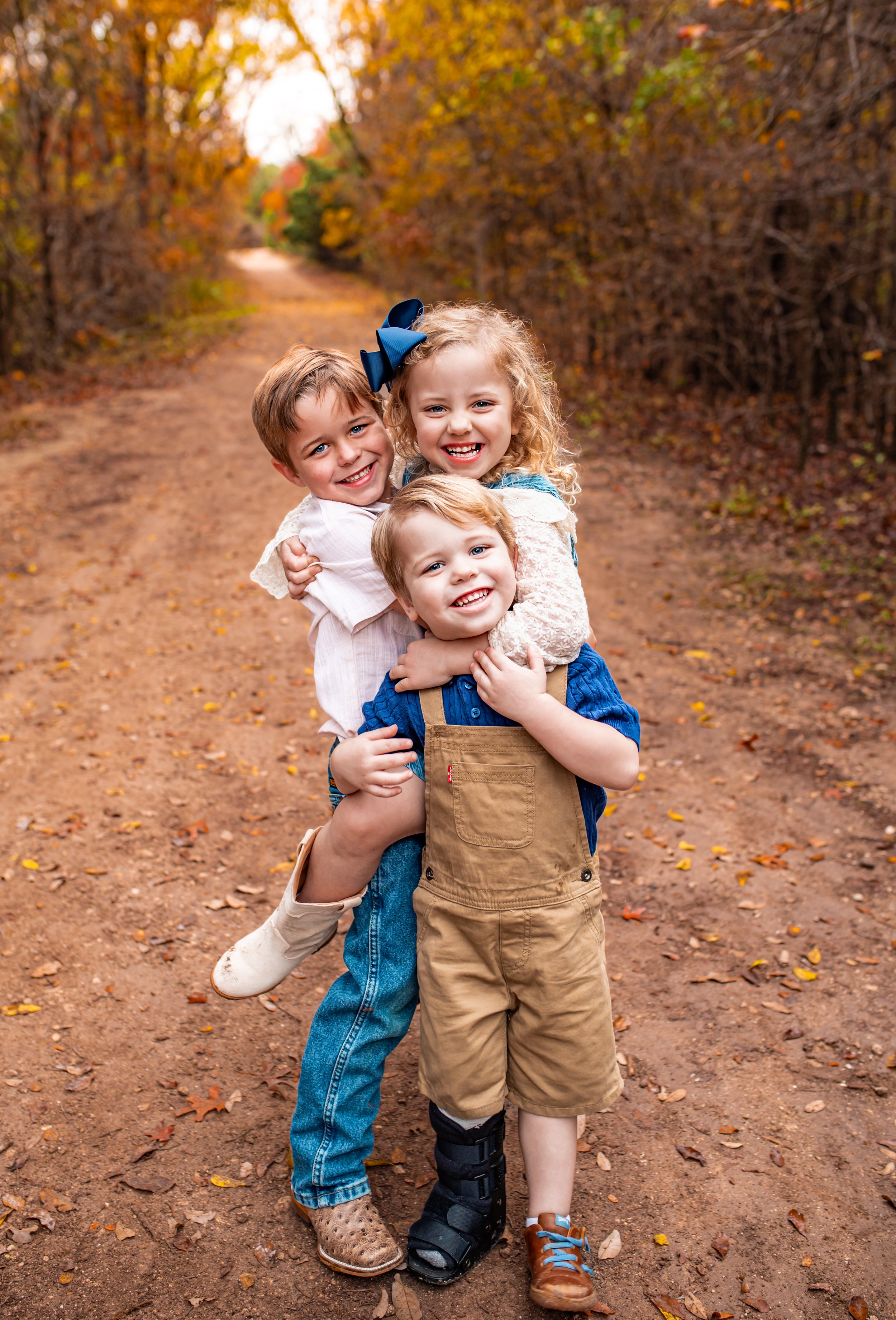 siblings hugging during outdoor golden hour photo session in Round Rock